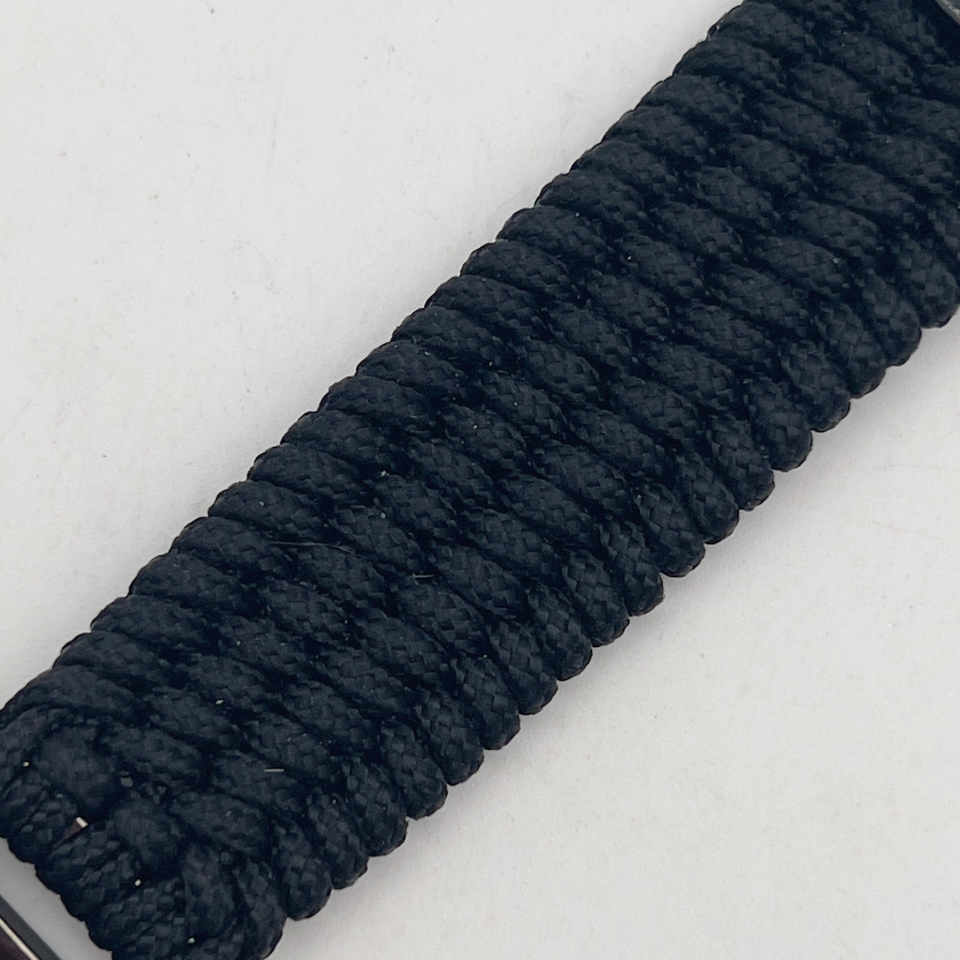 Thin, medium width, flexible and comfortable braided United States Marine Corps bracelet featuring a 24K gold USMC Eagle Globe and Anchor medallion, a black Cobra style tactical buckle and woven with black Type-1 paracord.