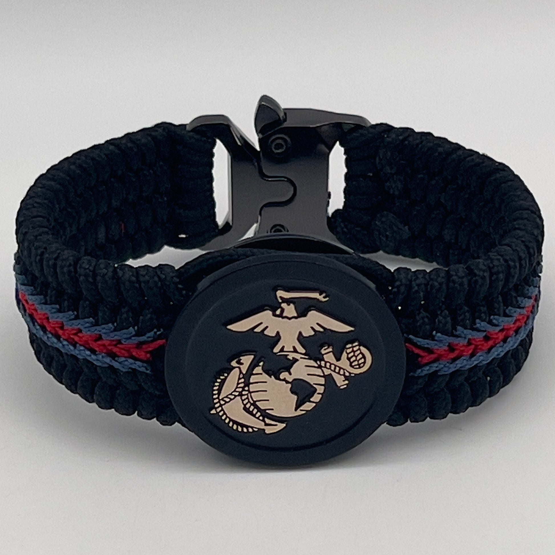 Thin, medium width, flexible and comfortable braided United States Marine Corps bracelet featuring a black USMC Eagle Globe and Anchor medallion, a black Cobra style tactical buckle and woven with black Type-1 paracord and blue and red nano cord.