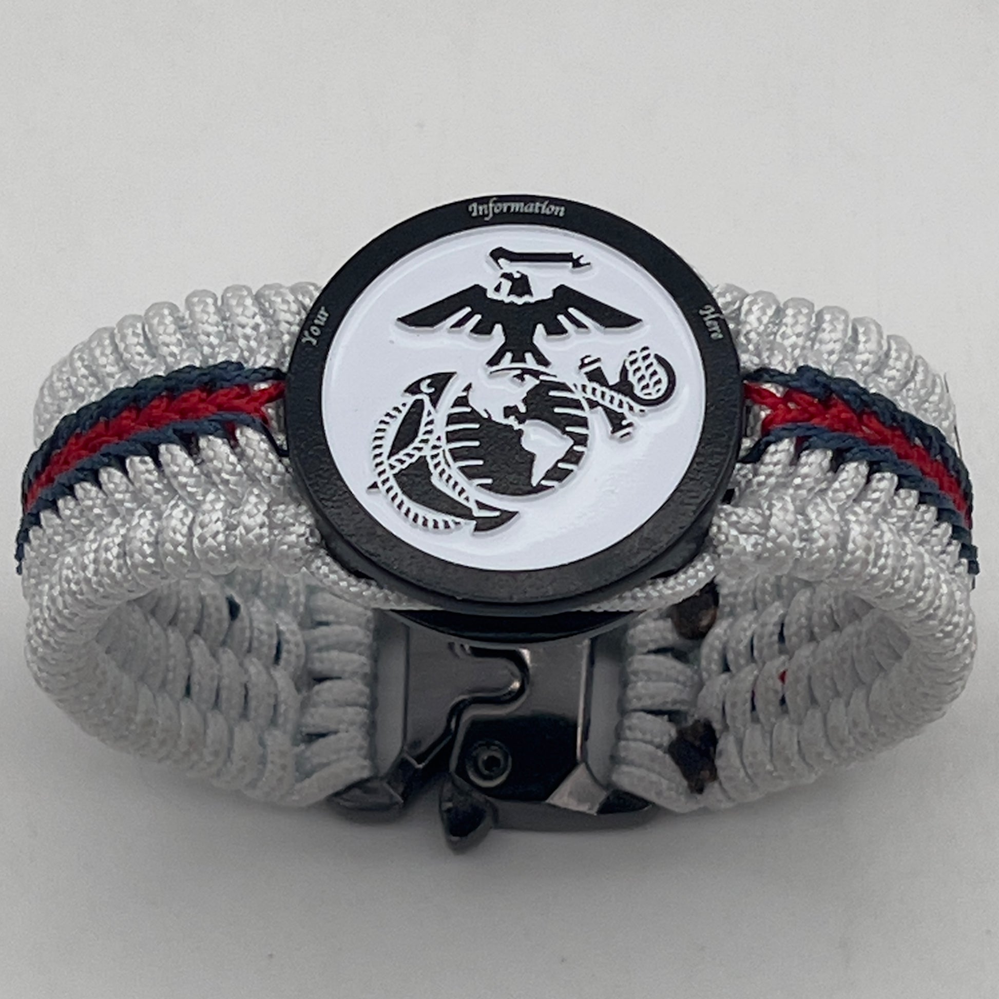 Thin, medium width, flexible and comfortable braided United States Marine Corps bracelet featuring a black USMC Eagle Globe and Anchor medallion, a black Cobra style tactical buckle and woven with white Type-1 paracord and stitched with red and blue nano cord.