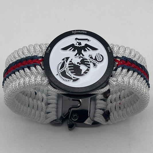 Thin, medium width, flexible and comfortable braided United States Marine Corps bracelet featuring a black USMC Eagle Globe and Anchor medallion, a black Cobra style tactical buckle and woven with white Type-1 paracord and stitched with red and blue nano cord.