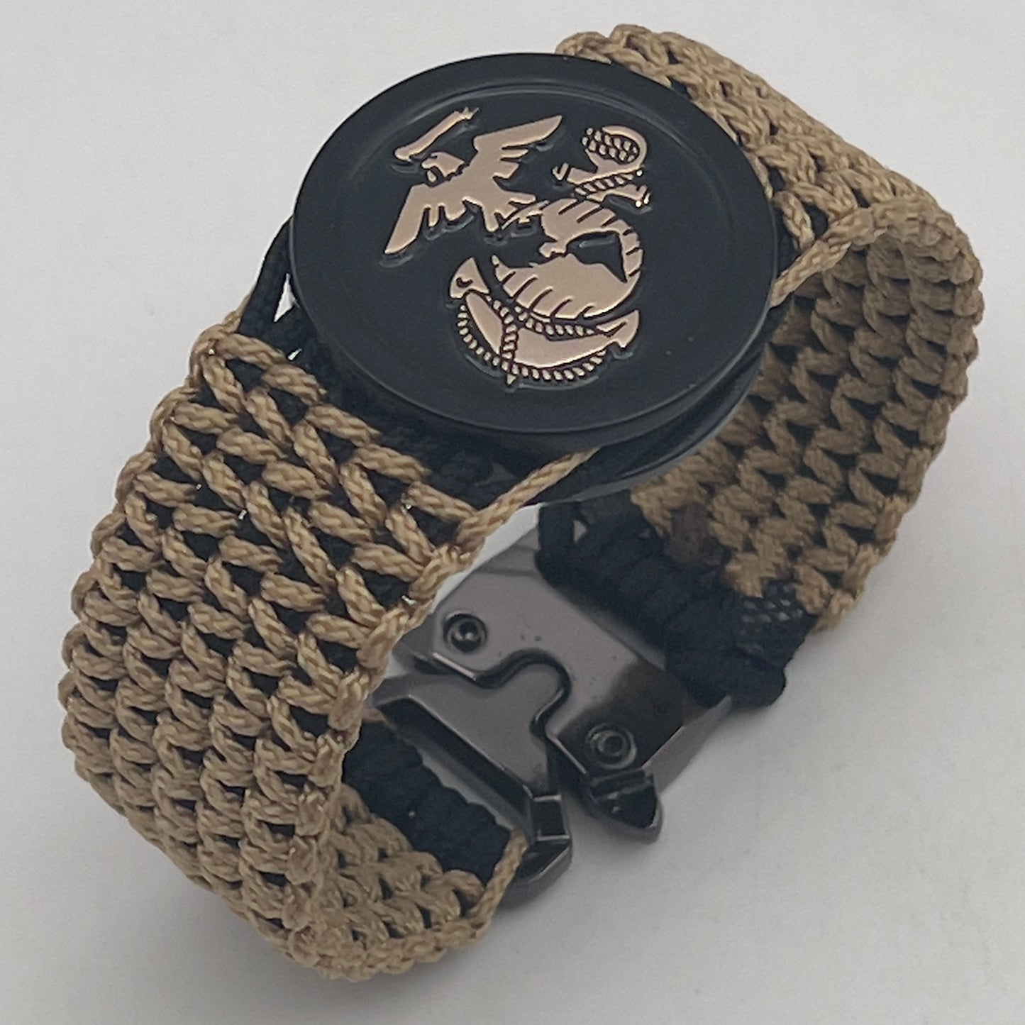 Thin, wide, flexible and comfortable braided United States Marine Corps bracelet featuring a gold USMC Eagle Globe and Anchor medallion, a black Cobra style tactical buckle and woven with black type-1 paracord and gold micro cord.