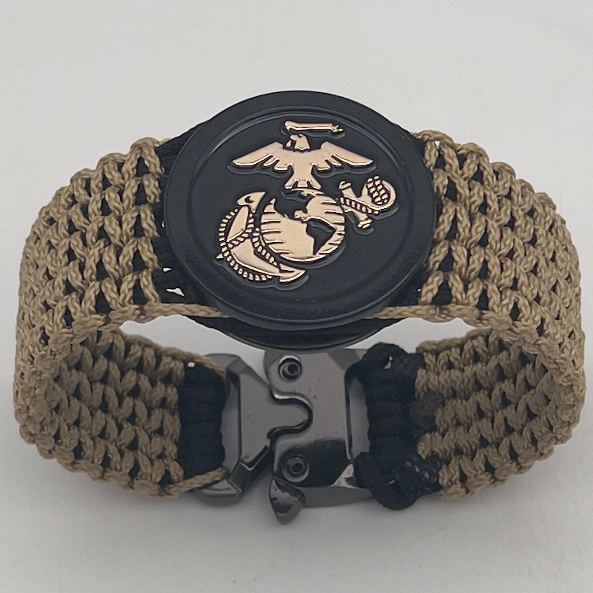 Thin, wide, flexible and comfortable braided United States Marine Corps bracelet featuring a gold USMC Eagle Globe and Anchor medallion, a black Cobra style tactical buckle and woven with black type-1 paracord and gold micro cord.