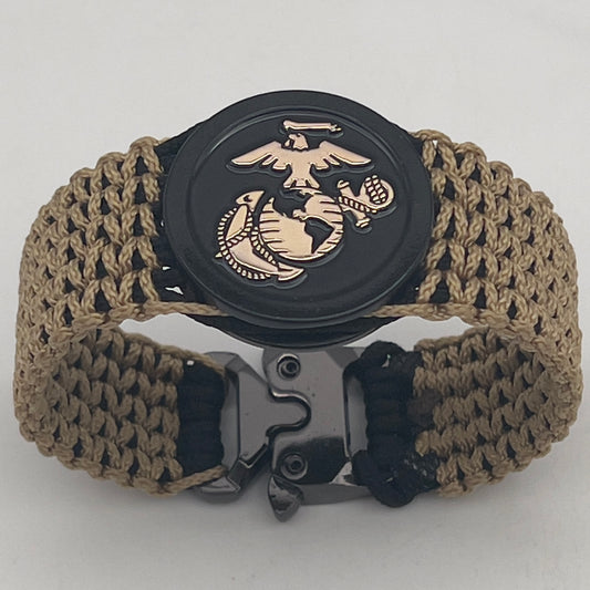 Thin, wide, flexible and comfortable braided United States Marine Corps bracelet featuring a gold USMC Eagle Globe and Anchor medallion, a black Cobra style tactical buckle and woven with black type-1 paracord and gold micro cord.