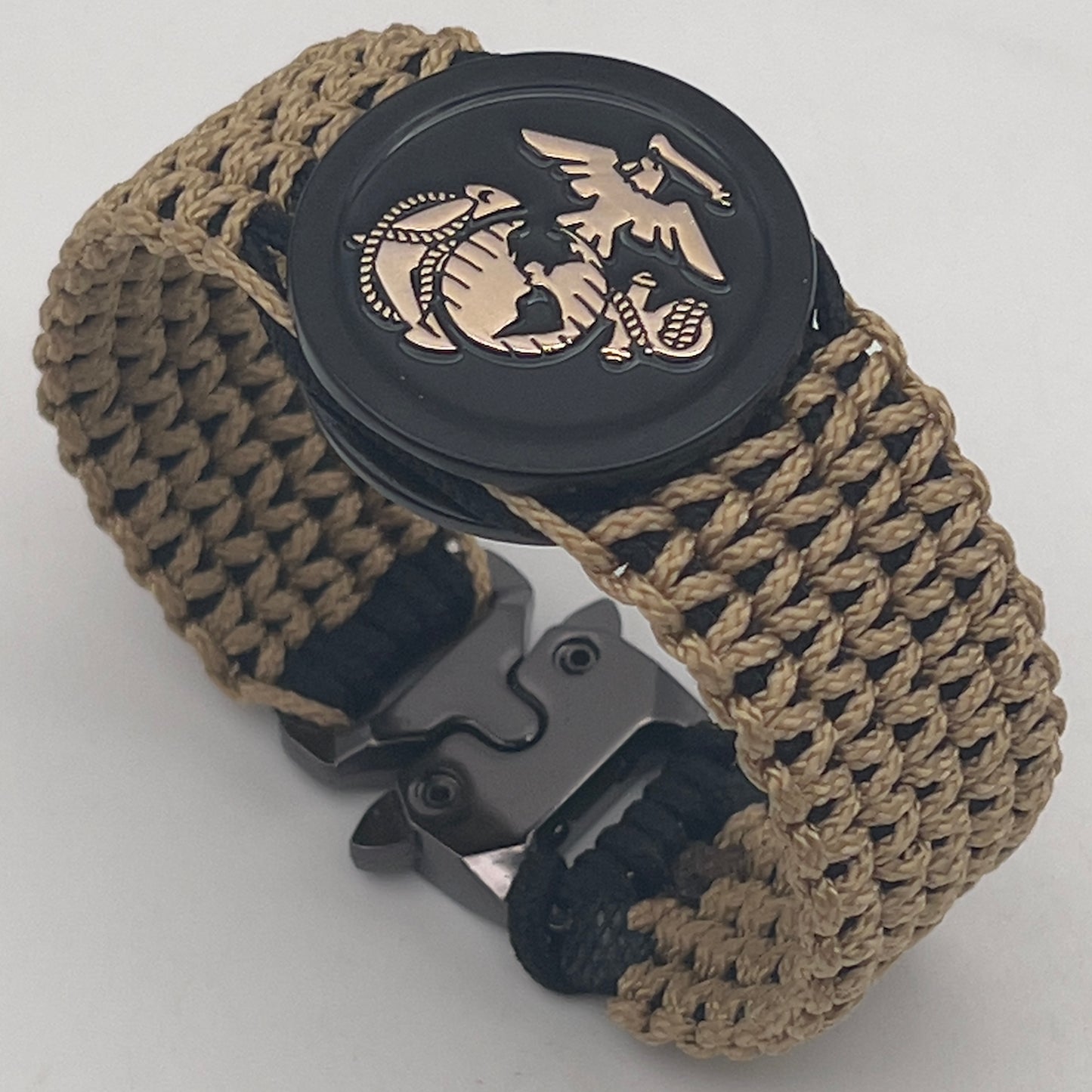 Thin, wide, flexible and comfortable braided United States Marine Corps bracelet featuring a gold USMC Eagle Globe and Anchor medallion, a black Cobra style tactical buckle and woven with black type-1 paracord and gold micro cord.