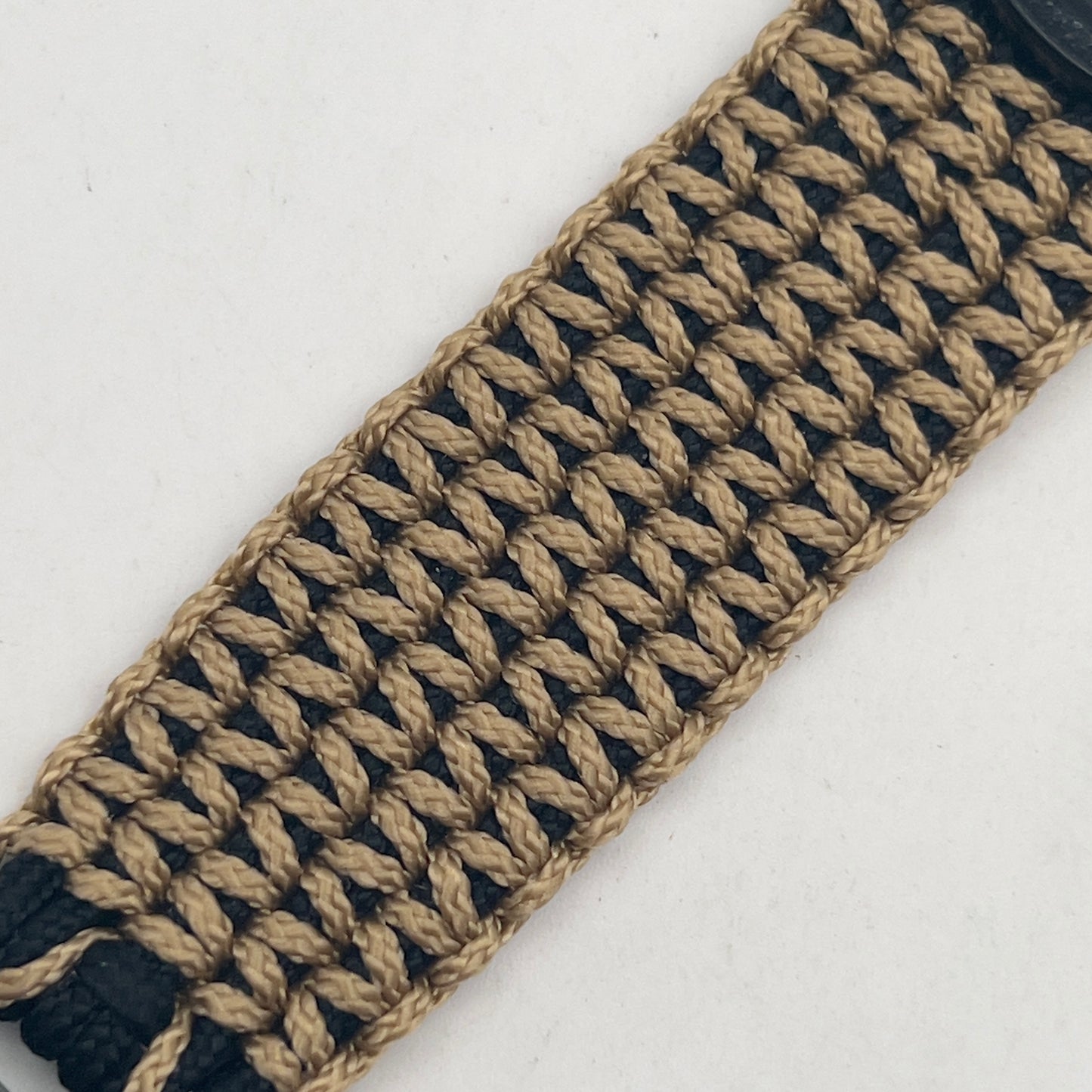 Thin, wide, flexible and comfortable braided United States Marine Corps bracelet featuring a gold USMC Eagle Globe and Anchor medallion, a black Cobra style tactical buckle and woven with black type-1 paracord and gold micro cord.