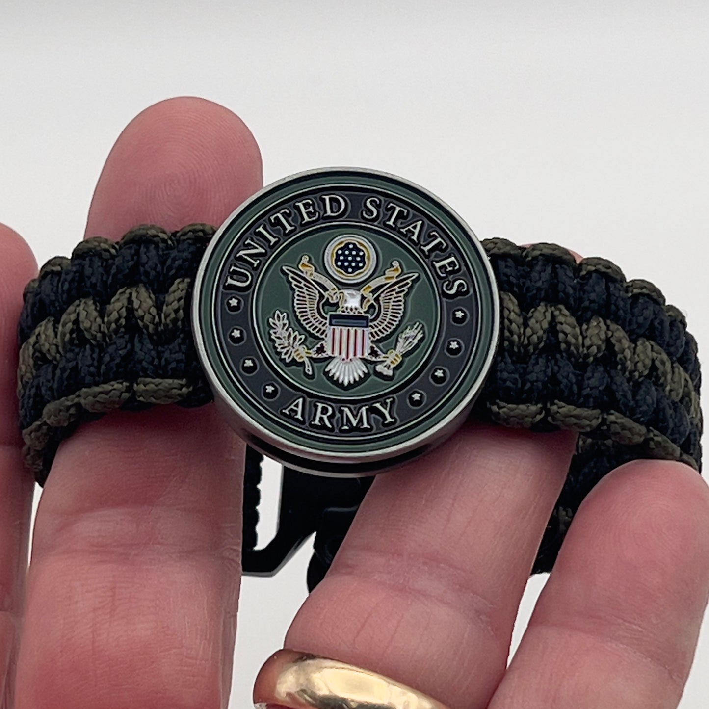 Thin, narrow, flexible and comfortable braided United States Army bracelet featuring an official US Army medallion, a black Cobra style tactical buckle and woven with black and olive drab Type-1 paracord.