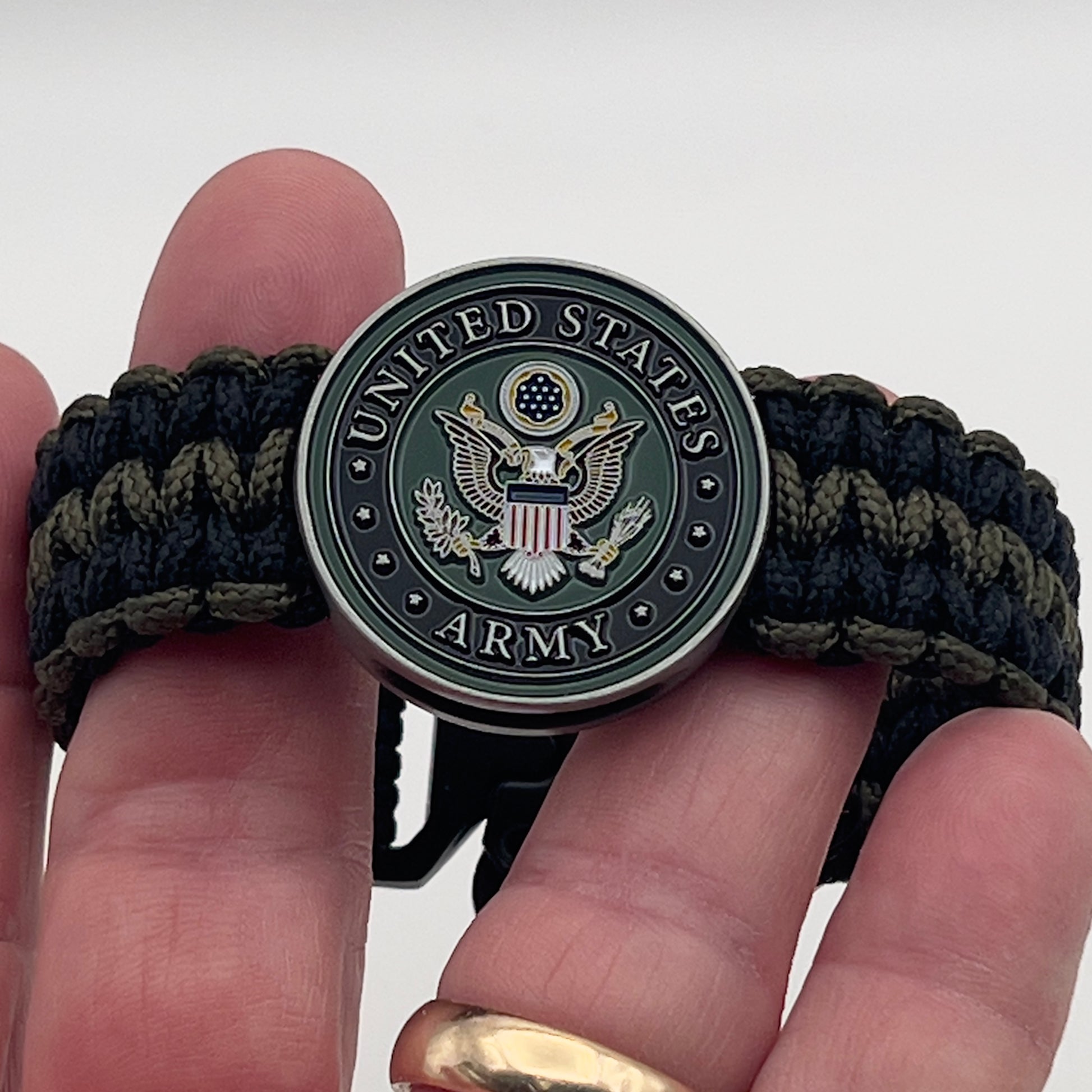 Thin, narrow, flexible and comfortable braided United States Army bracelet featuring an official US Army medallion, a black Cobra style tactical buckle and woven with black and olive drab Type-1 paracord.
