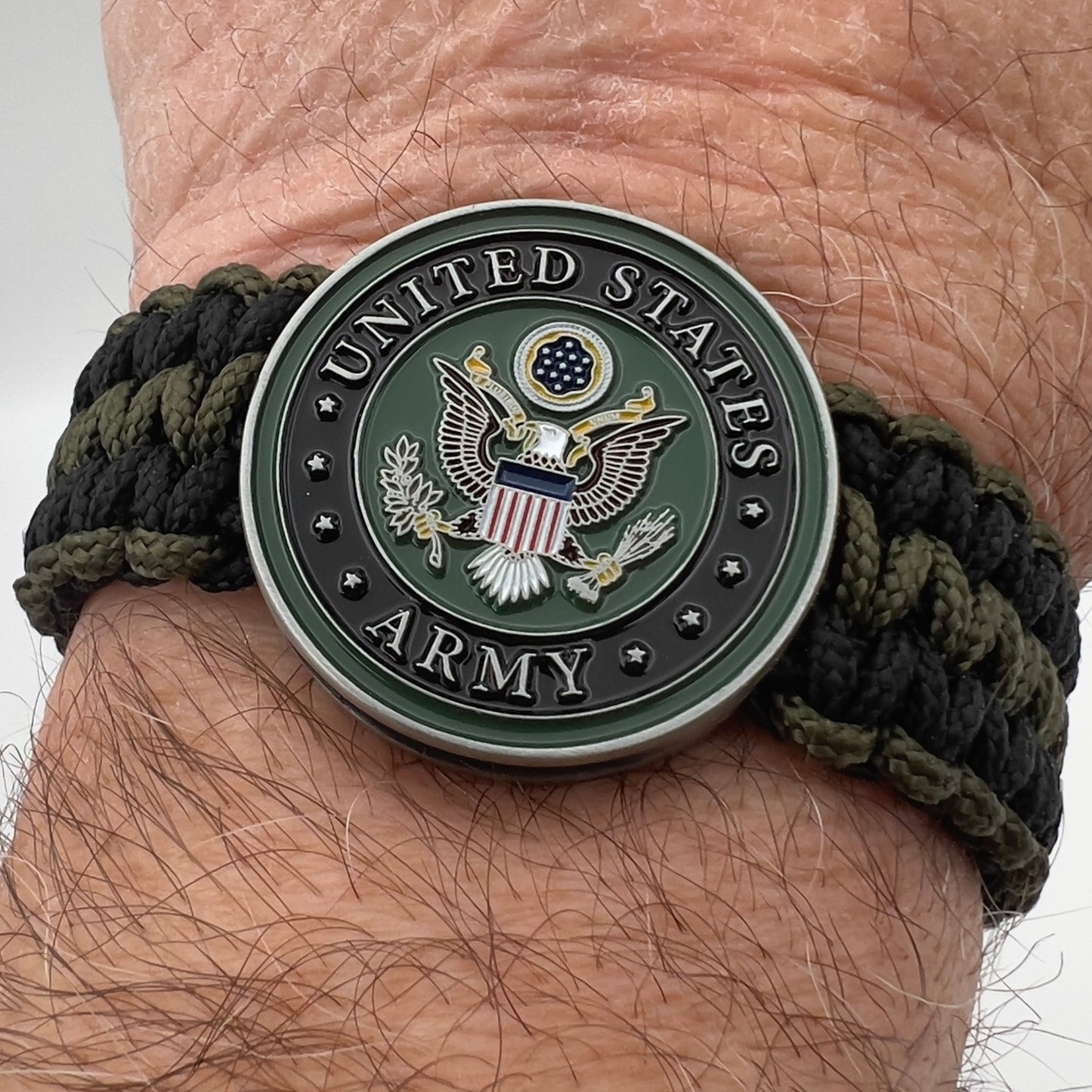 Thin, narrow, flexible and comfortable braided United States Army bracelet featuring an official US Army medallion, a black Cobra style tactical buckle and woven with black and olive drab Type-1 paracord.
