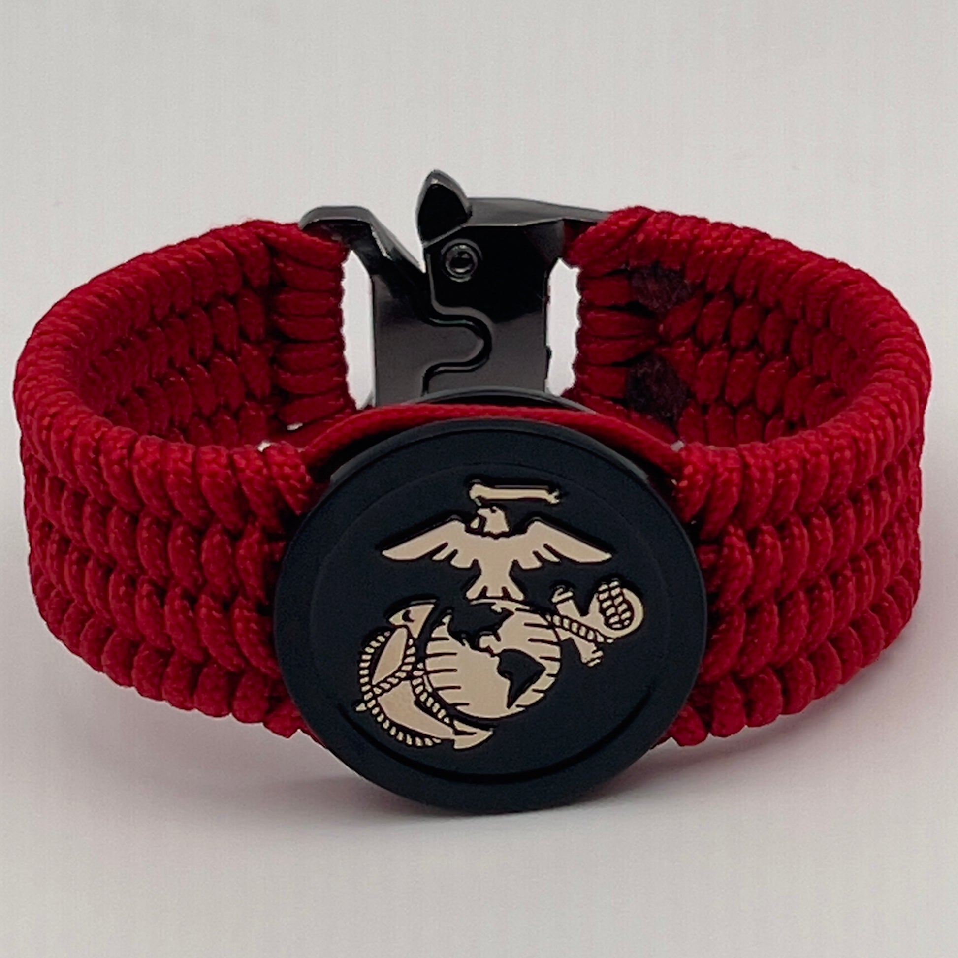 Thin, medium width, flexible and comfortable braided United States Marine Corps bracelet featuring a 24K gold USMC Eagle Globe and Anchor medallion, a black Cobra style tactical buckle and woven with red Type-1 paracord.
