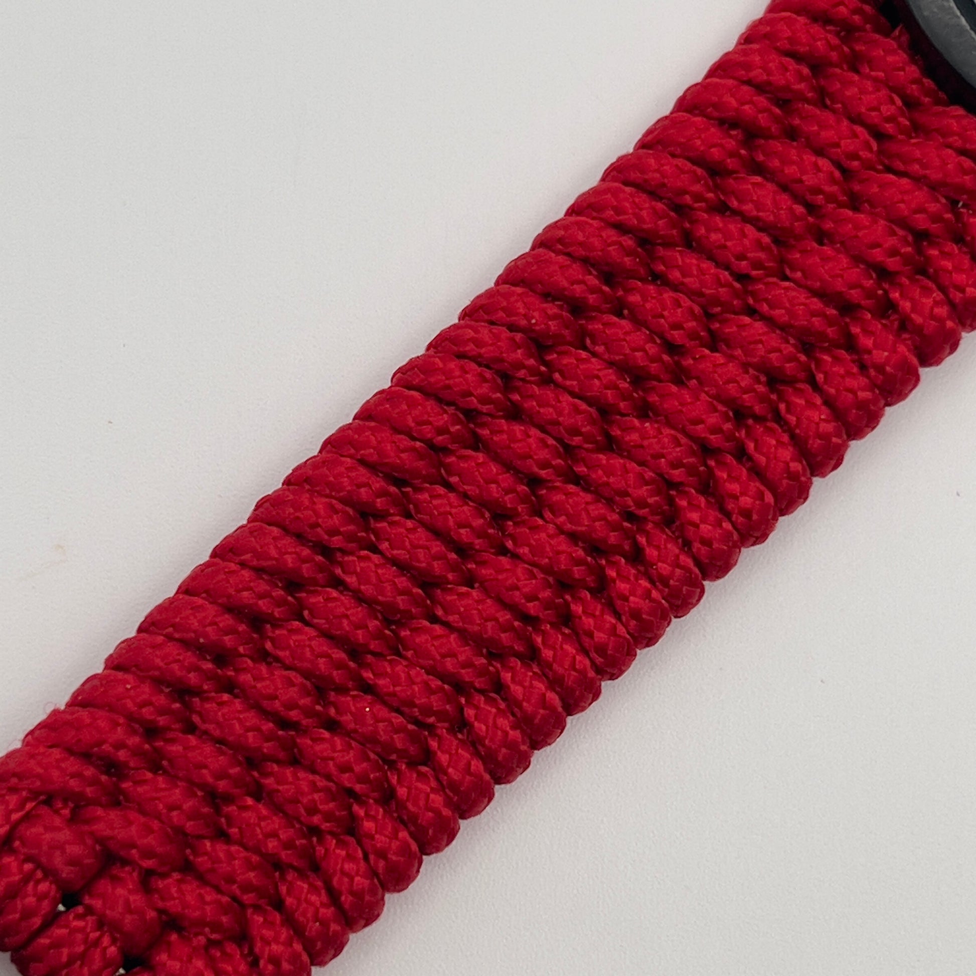 Thin, medium width, flexible and comfortable braided United States Marine Corps bracelet featuring a 24K gold USMC Eagle Globe and Anchor medallion, a black Cobra style tactical buckle and woven with red Type-1 paracord.