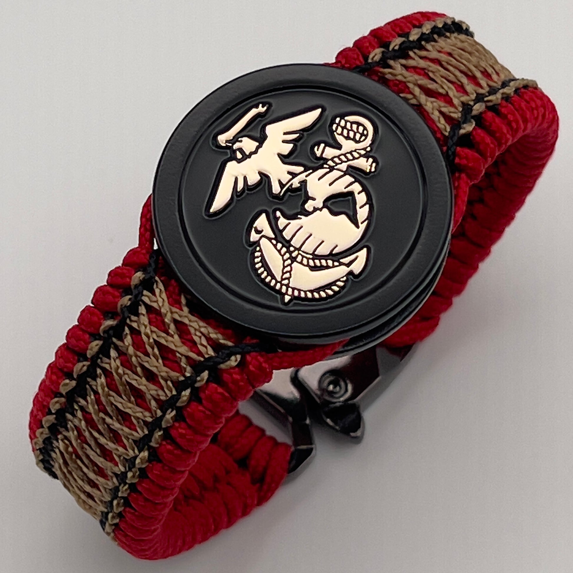 Thin, narrow, flexible and comfortable braided United States Marine Corps bracelet featuring the official US Marine Corps Eagle, Globe and Anchor medallion, a black Cobra style tactical buckle and woven with red Type-1 paracord and center stitched with black and gold nano cord.