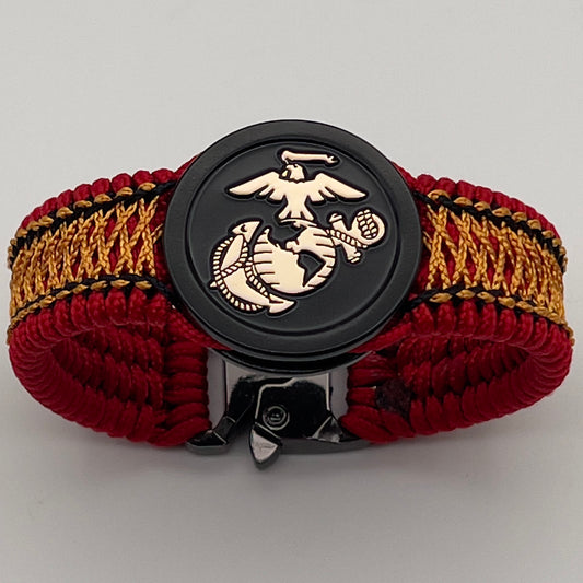 Thin, narrow, flexible and comfortable braided United States Marine Corps bracelet featuring the official US Marine Corps Eagle, Globe and Anchor medallion, a black Cobra style tactical buckle and woven with red Type-1 paracord and center stitched with black and goldenrod nano cord.