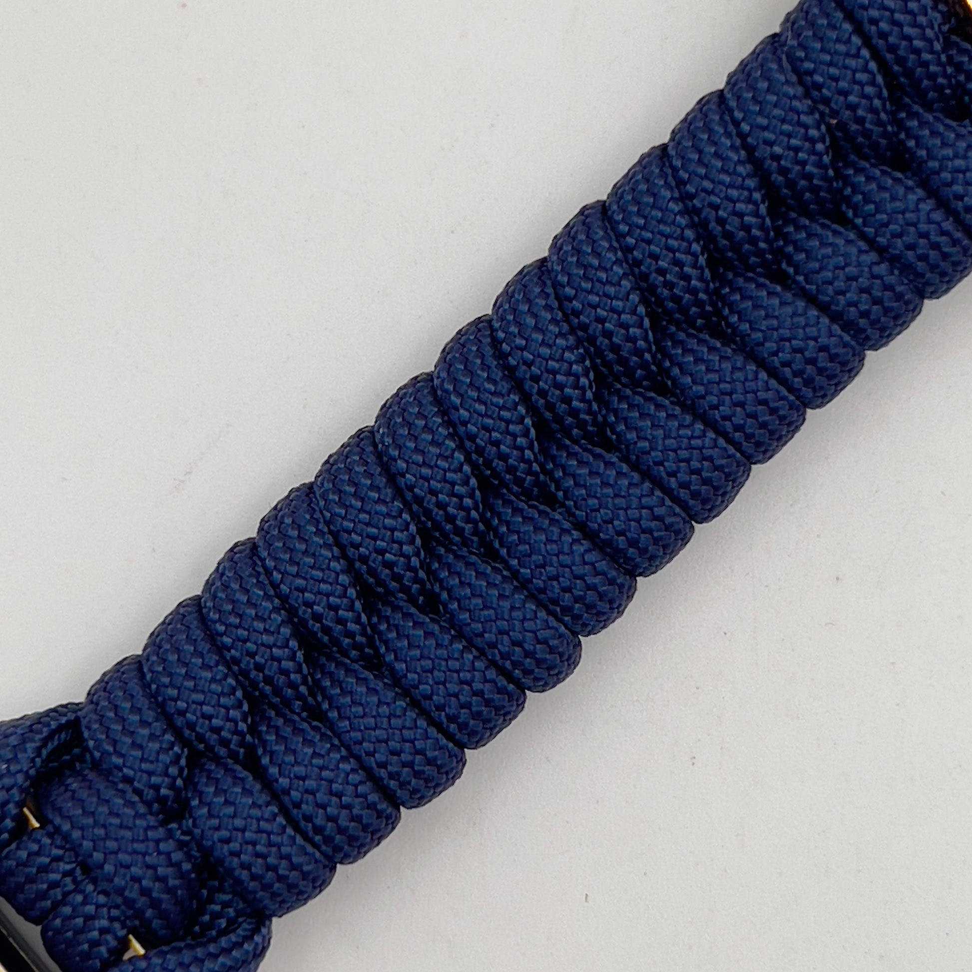 Thick and comfortable braided United States Marine Corps bracelet featuring a 24K gold and silver plated USMC officer Eagle Globe and Anchor medallion, a Cobra style tactical buckle and woven with Navy blue paracord.
