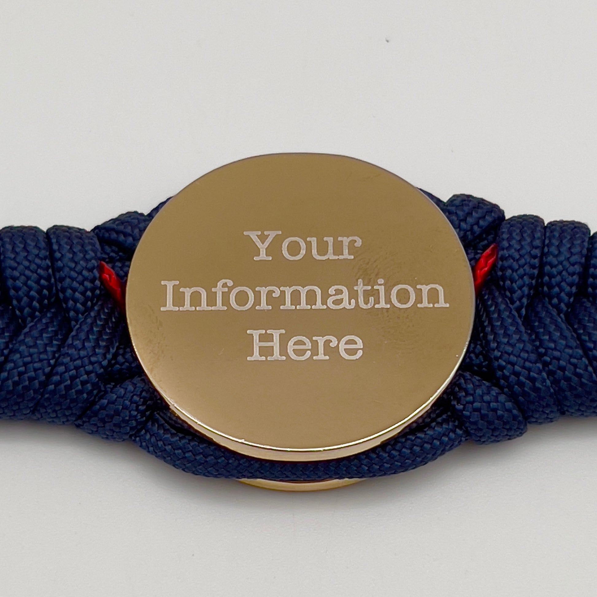 Thick and comfortable braided United States Marine Corps bracelet featuring a 24K gold and silver plated USMC officer Eagle Globe and Anchor medallion, a Cobra style tactical buckle and woven with Navy blue and Imperial red paracord.