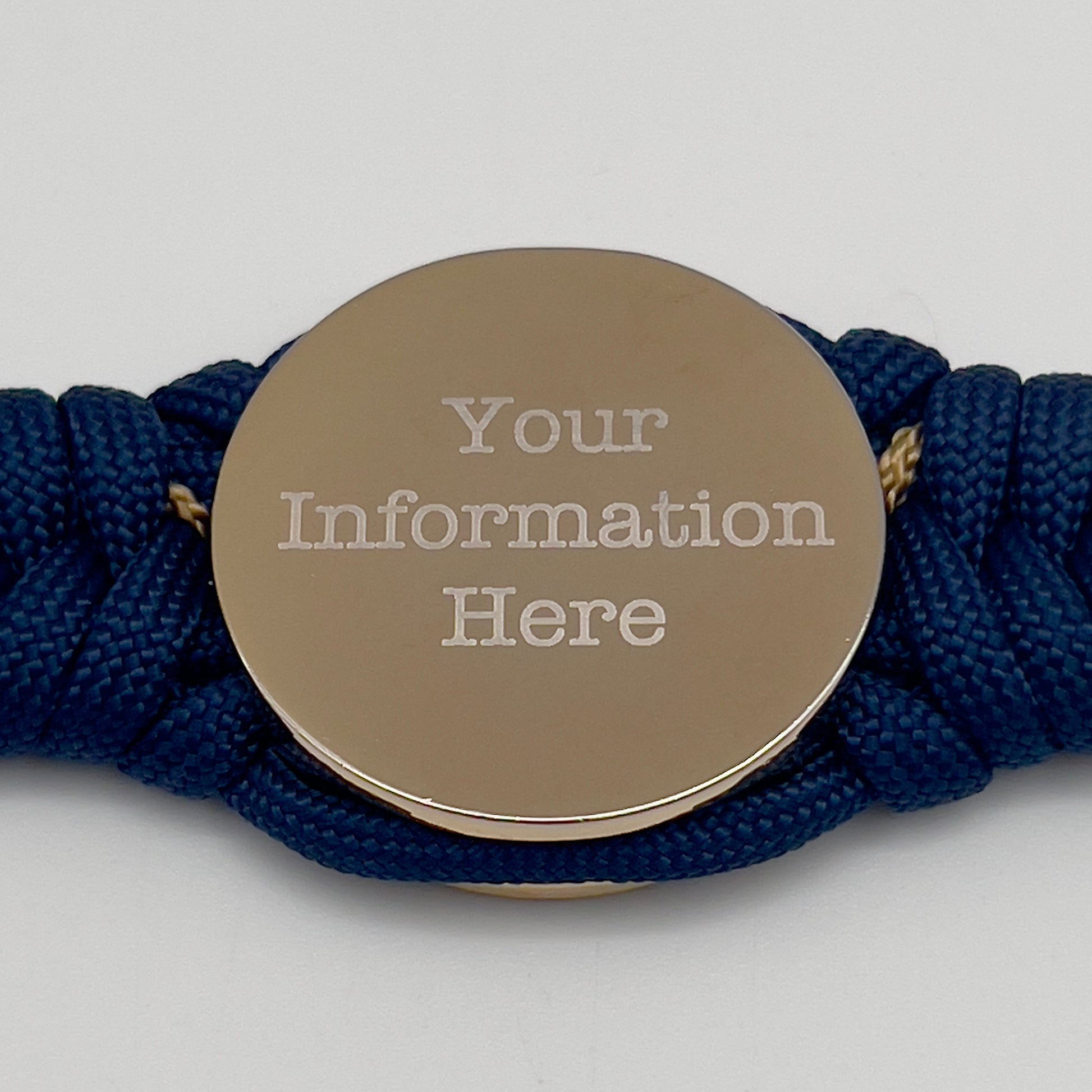 Thick and comfortable braided United States Marine Corps bracelet featuring a 24K gold and silver plated USMC officer Eagle Globe and Anchor medallion, a Cobra style tactical buckle and woven with Navy blue and gold paracord.