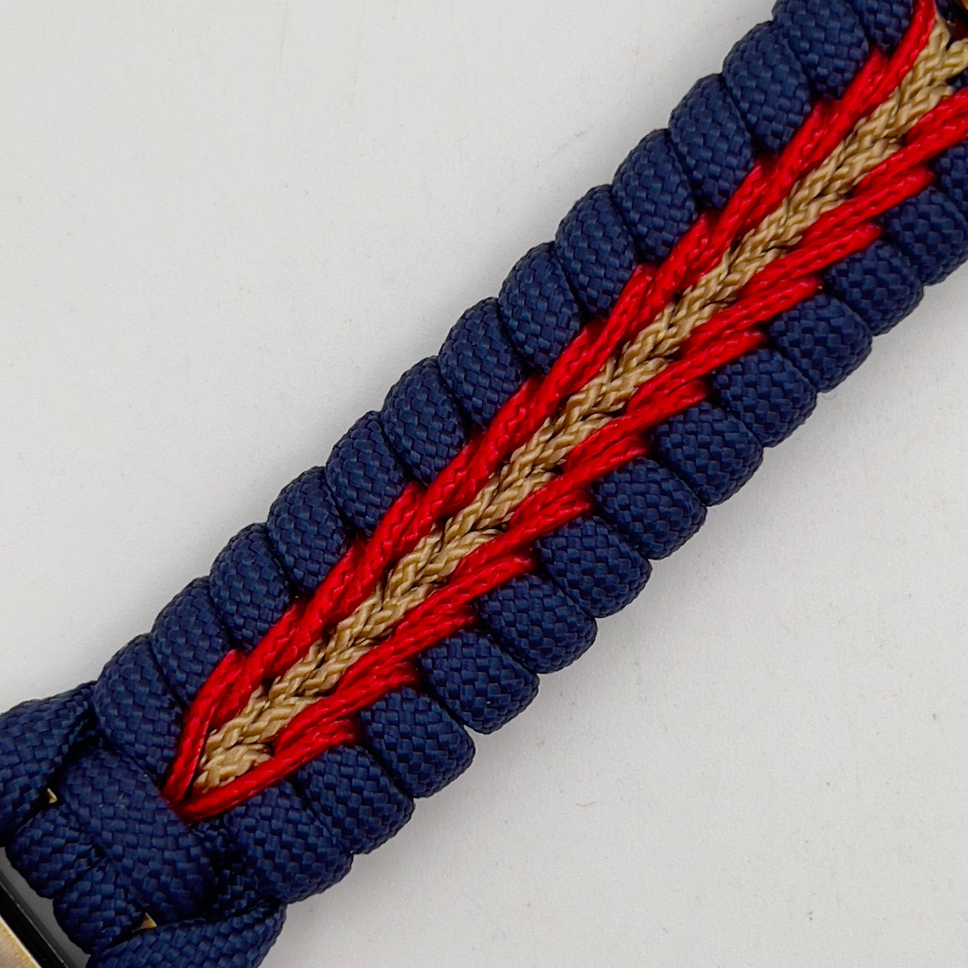 Thick and comfortable braided United States Marine Corps bracelet featuring a 24K gold and silver plated USMC officer Eagle Globe and Anchor medallion, a Cobra style tactical buckle and woven with Navy blue, Imperial red and gold paracord.
