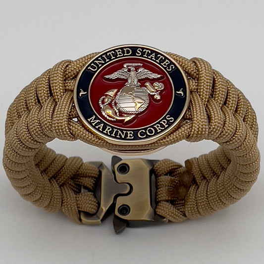 Thick and comfortable braided United States Marine Corps bracelet featuring a 24K gold and silver plated USMC officer Eagle Globe and Anchor medallion, a Cobra style tactical buckle and woven with gold 550 paracord.