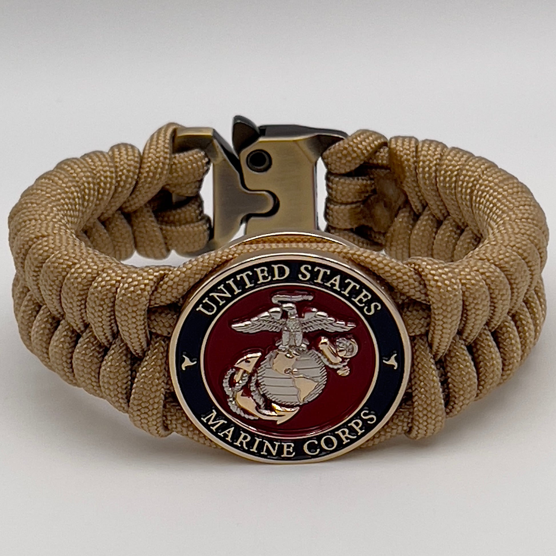 Thick and comfortable braided United States Marine Corps bracelet featuring a 24K gold and silver plated USMC officer Eagle Globe and Anchor medallion, a Cobra style tactical buckle and woven with gold 550 paracord.
