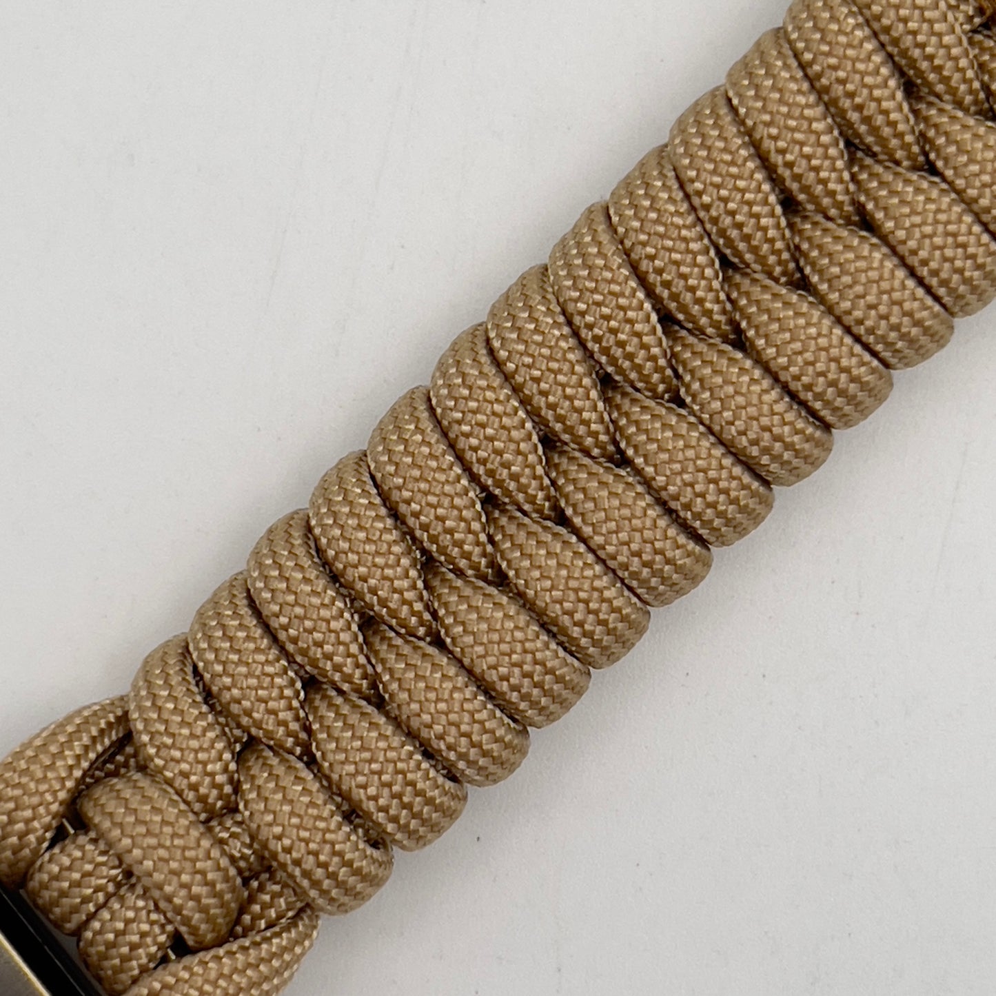 Thick and comfortable braided United States Marine Corps bracelet featuring a 24K gold and silver plated USMC officer Eagle Globe and Anchor medallion, a Cobra style tactical buckle and woven with gold 550 paracord.