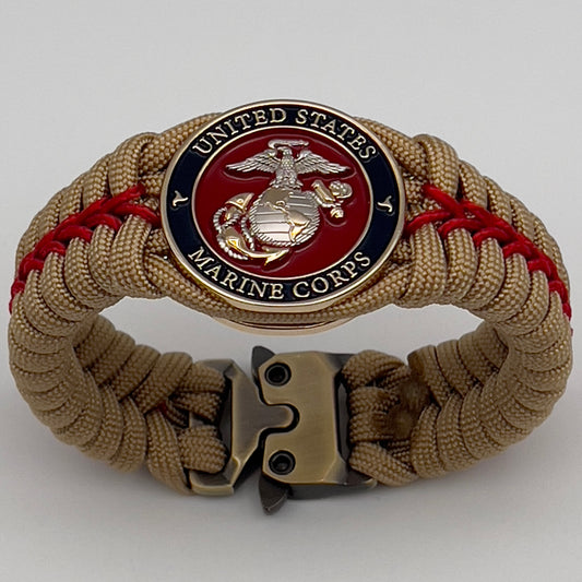 Thick and comfortable braided United States Marine Corps bracelet featuring a 24K gold and silver plated USMC officer Eagle Globe and Anchor medallion, a Cobra style tactical buckle and woven with gold 550 and Imperial red micro paracord.