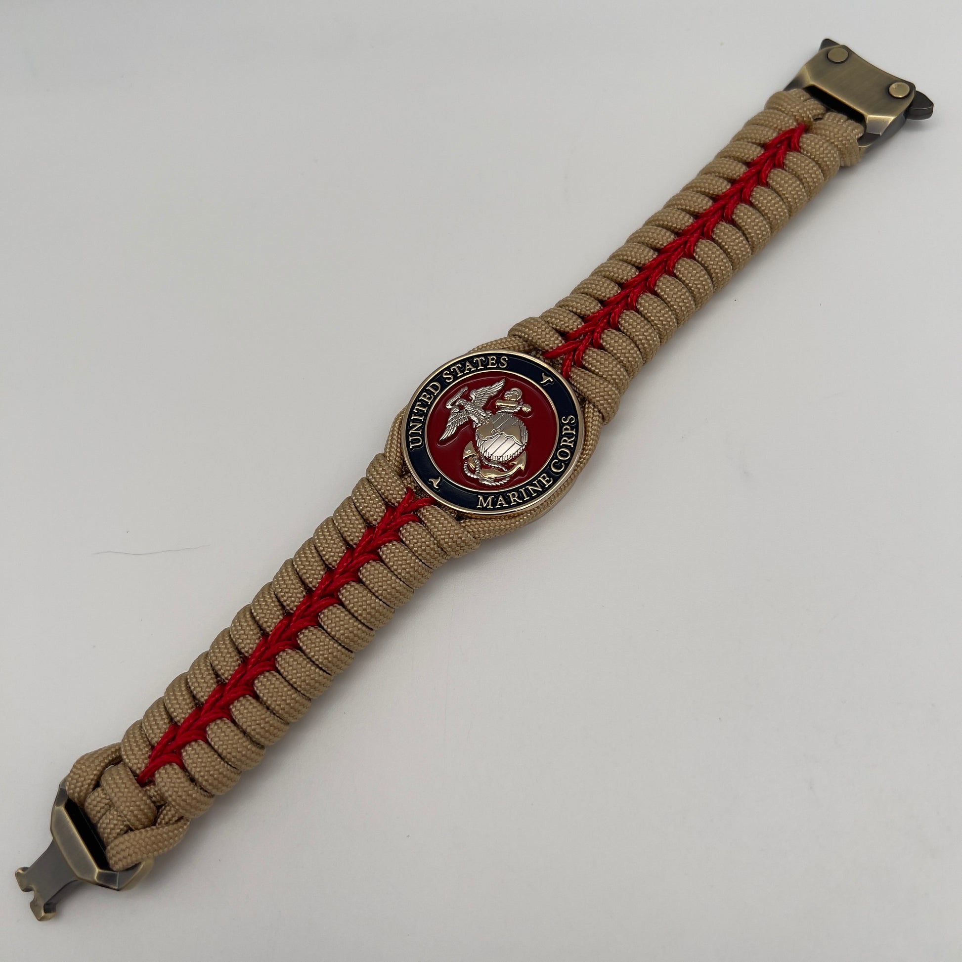 Thick and comfortable braided United States Marine Corps bracelet featuring a 24K gold and silver plated USMC officer Eagle Globe and Anchor medallion, a Cobra style tactical buckle and woven with gold 550 and Imperial red micro paracord.