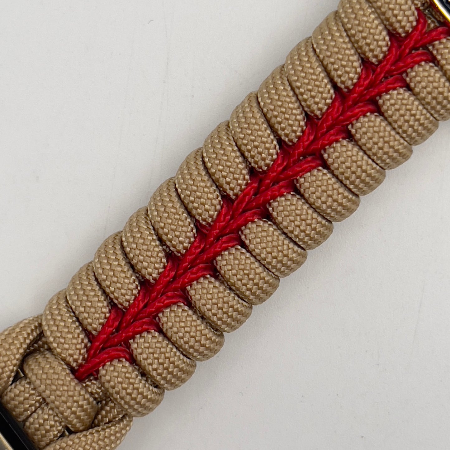 Thick and comfortable braided United States Marine Corps bracelet featuring a 24K gold and silver plated USMC officer Eagle Globe and Anchor medallion, a Cobra style tactical buckle and woven with gold 550 and Imperial red micro paracord.