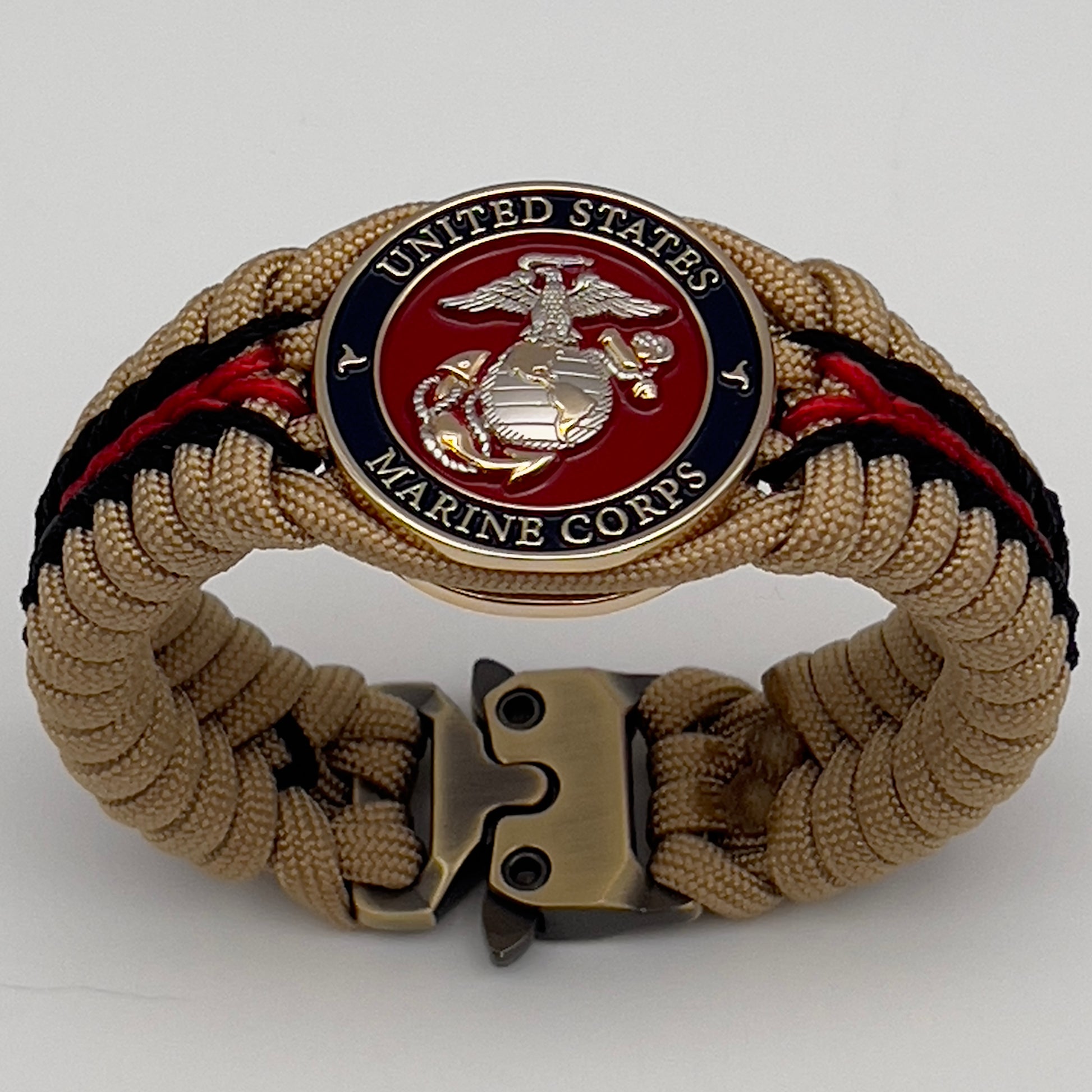 Thick and comfortable braided United States Marine Corps bracelet featuring a 24K gold and silver plated USMC officer Eagle Globe and Anchor medallion, a Cobra style tactical buckle and woven with gold 550 and Imperial red micro paracord.