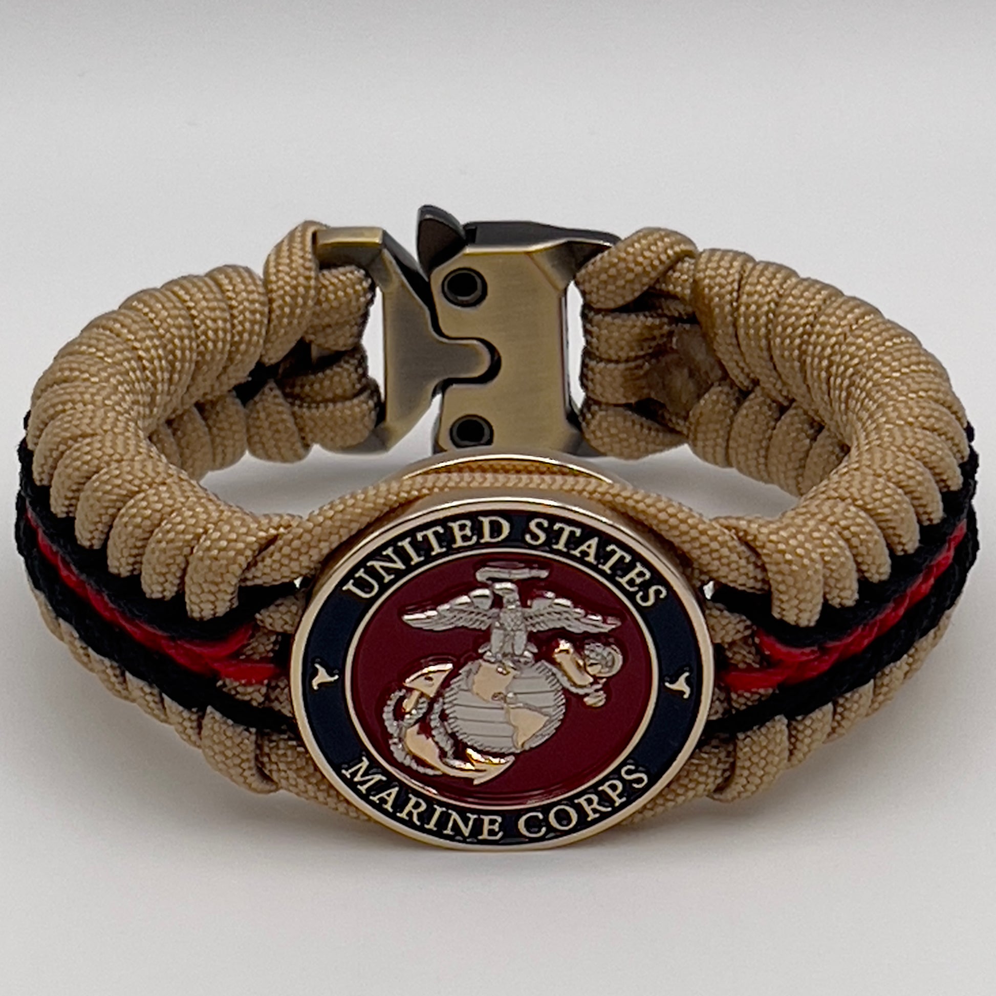 Thick and comfortable braided United States Marine Corps bracelet featuring a 24K gold and silver plated USMC officer Eagle Globe and Anchor medallion, a Cobra style tactical buckle and woven with gold 550 and Imperial red micro paracord.