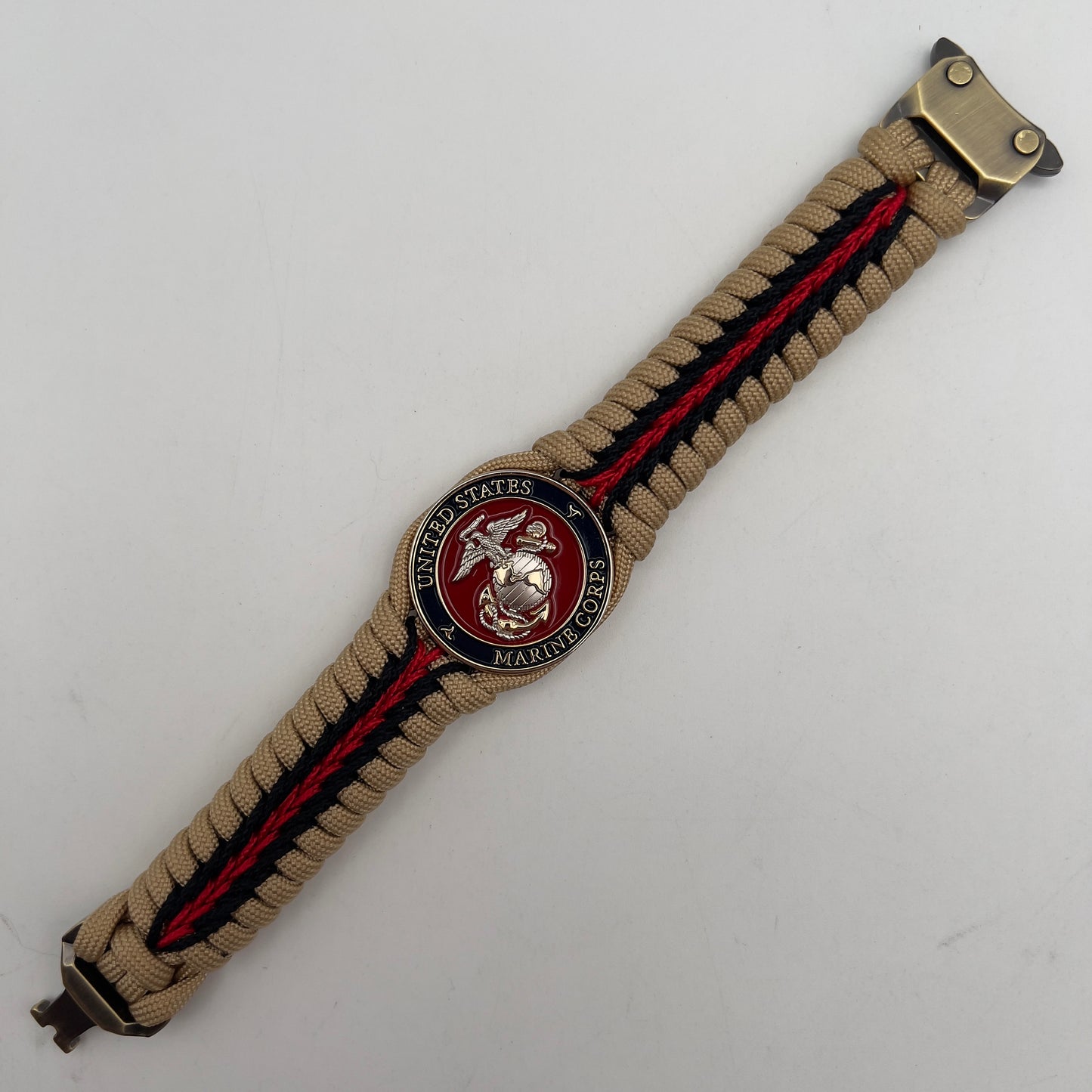 Thick and comfortable braided United States Marine Corps bracelet featuring a 24K gold and silver plated USMC officer Eagle Globe and Anchor medallion, a Cobra style tactical buckle and woven with gold 550 and Imperial red micro paracord.