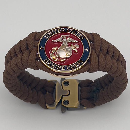 Thick and comfortable braided United States Marine Corps bracelet featuring a 24K gold and silver plated USMC officer Eagle Globe and Anchor medallion, a Cobra style tactical buckle and woven with Coyote brown 550 paracord.