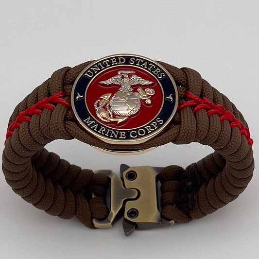 Thick, semi-rigid and comfortable braided United States Marine Corps bracelet featuring a 24K gold and silver plated USMC officer Eagle Globe and Anchor medallion, a Cobra style tactical buckle and woven with Coyote brown 550 and Imperial red micro paracord.