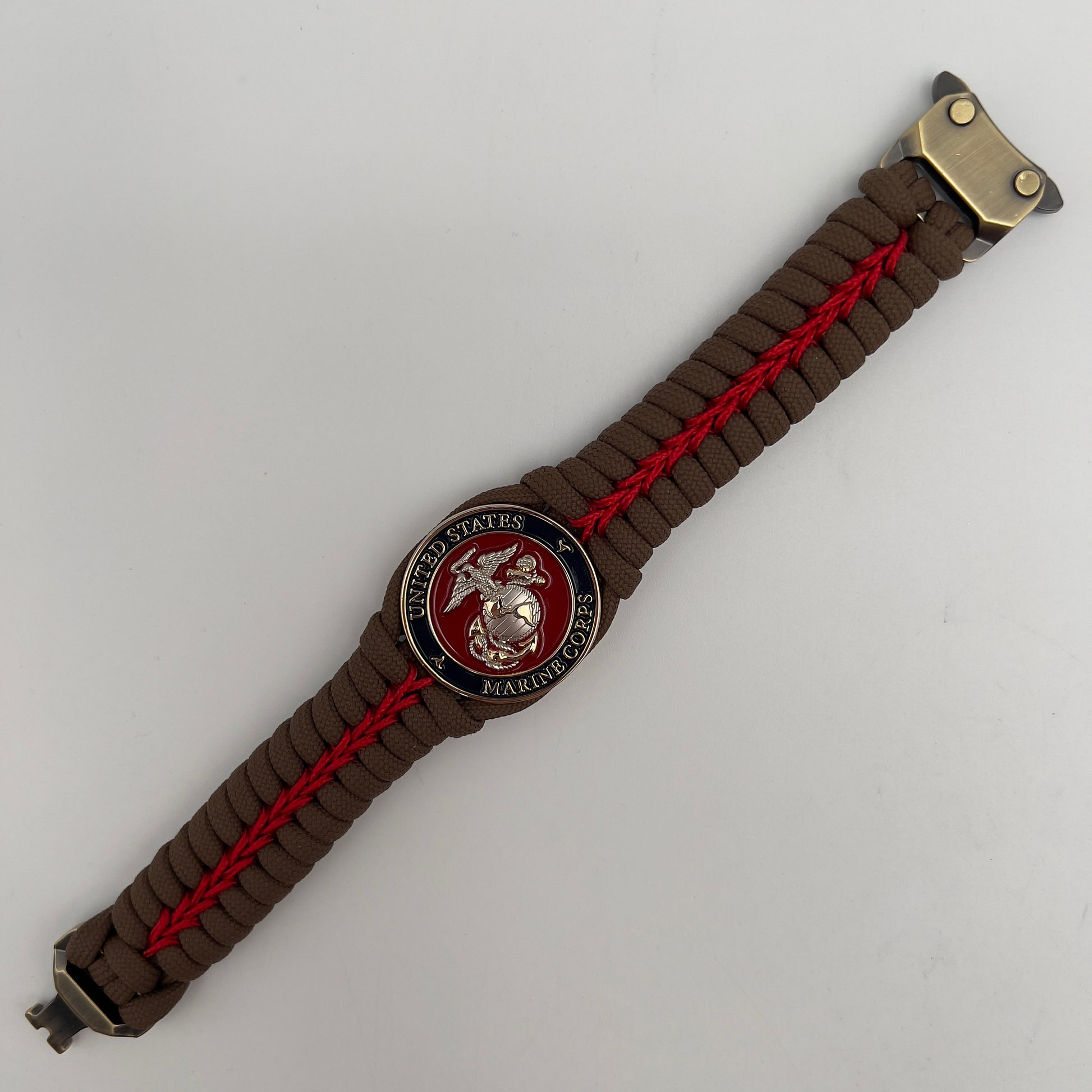 Thick, semi-rigid and comfortable braided United States Marine Corps bracelet featuring a 24K gold and silver plated USMC officer Eagle Globe and Anchor medallion, a Cobra style tactical buckle and woven with Coyote brown 550 and Imperial red micro paracord.