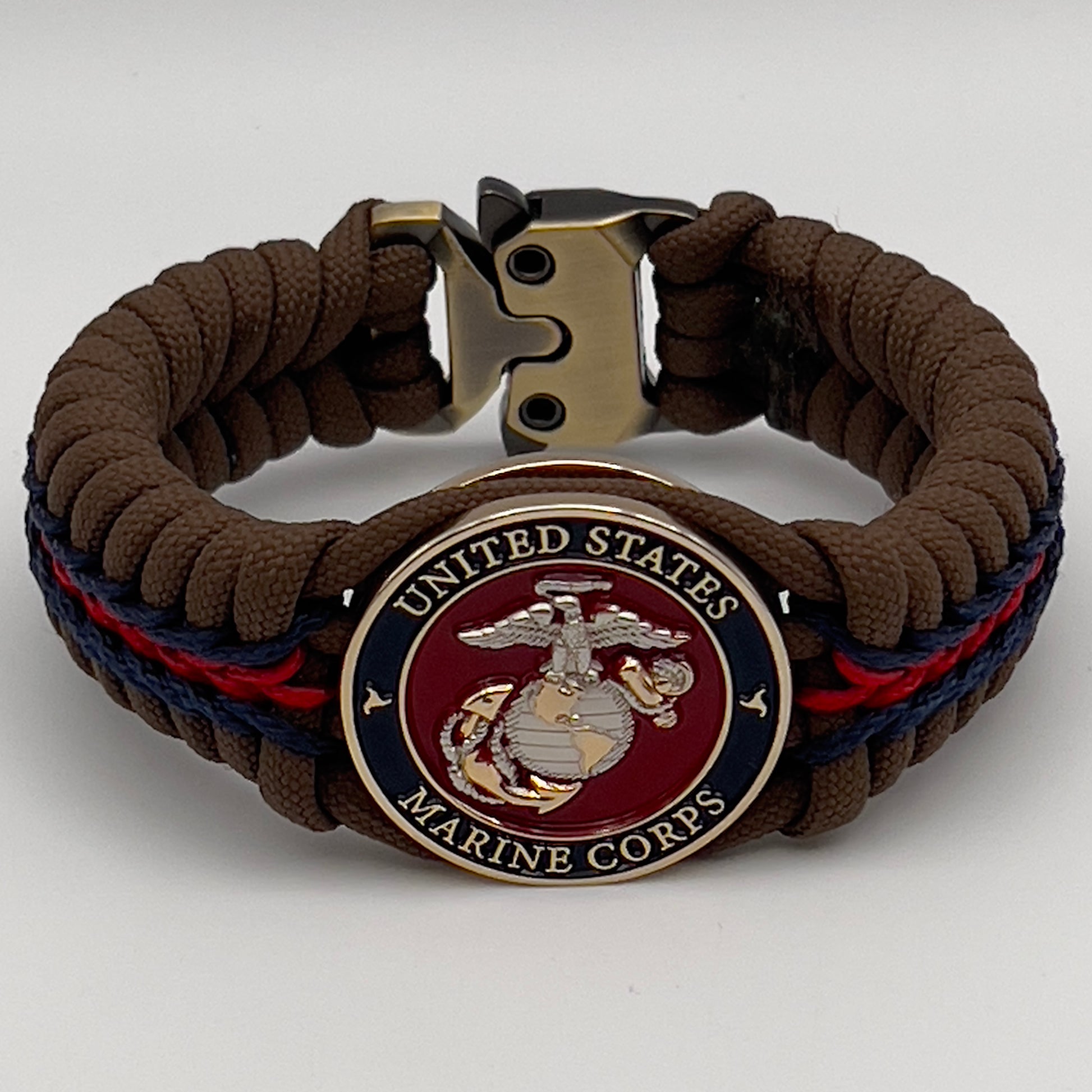 Thick, semi-rigid and comfortable braided United States Marine Corps bracelet featuring a 24K gold and silver plated USMC officer Eagle Globe and Anchor medallion, a Cobra style tactical buckle and woven with Coyote brown 550, Navy blue and Imperial red micro paracord.