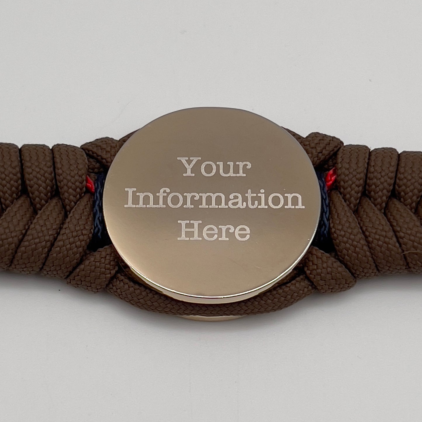 Thick, semi-rigid and comfortable braided United States Marine Corps bracelet featuring a 24K gold and silver plated USMC officer Eagle Globe and Anchor medallion, a Cobra style tactical buckle and woven with Coyote brown 550, Navy blue and Imperial red micro paracord.
