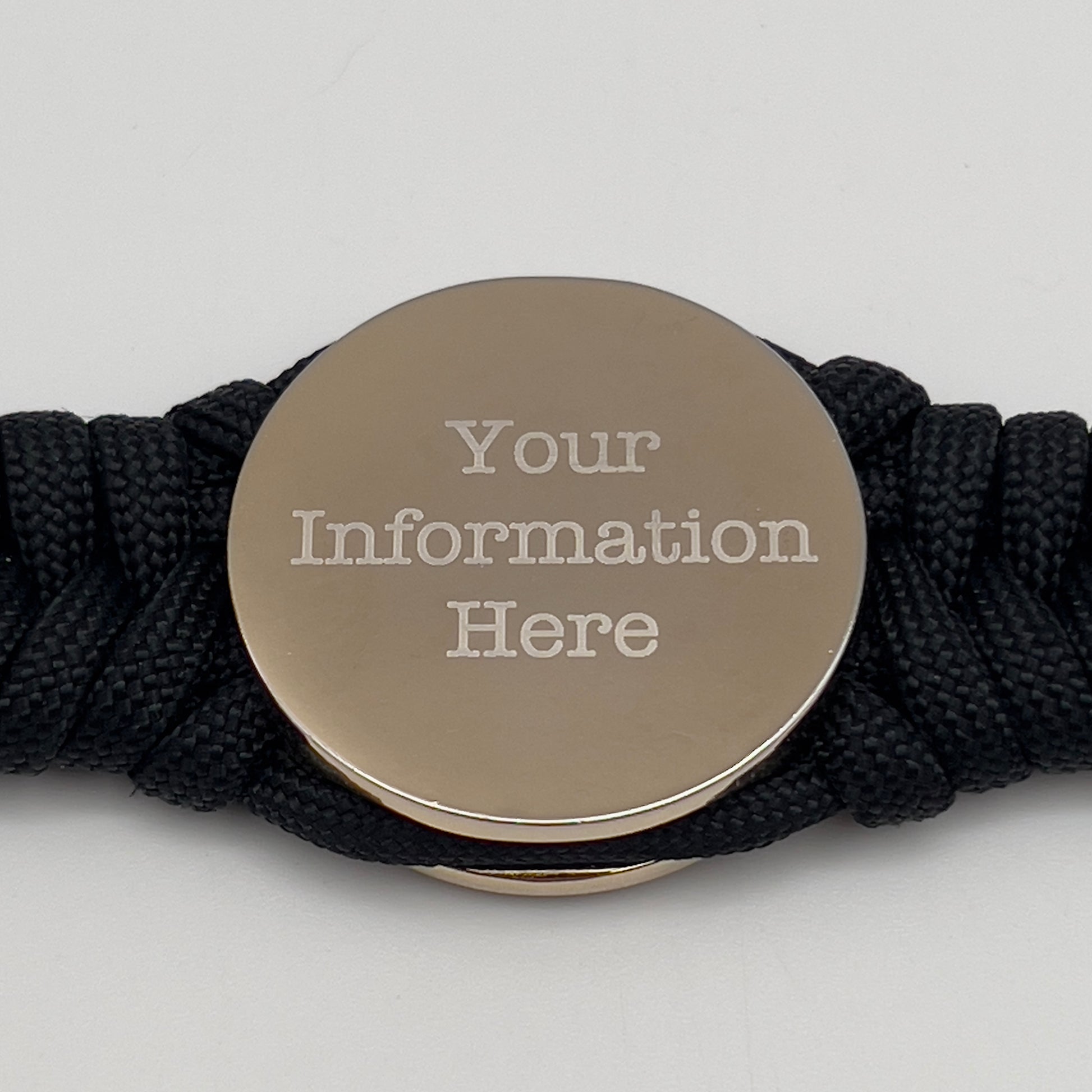 Thick, semi-rigid and comfortable braided United States Marine Corps bracelet featuring a 24K gold and silver plated USMC officer Eagle Globe and Anchor medallion, a black Cobra style tactical buckle and woven with black 550 paracord.