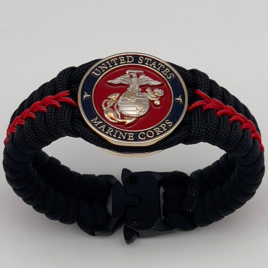 Thick, semi-rigid and comfortable braided United States Marine Corps bracelet featuring a 24K gold and silver plated USMC officer Eagle Globe and Anchor medallion, a black Cobra style tactical buckle and woven with black 550 and Imperial red micro paracord.
