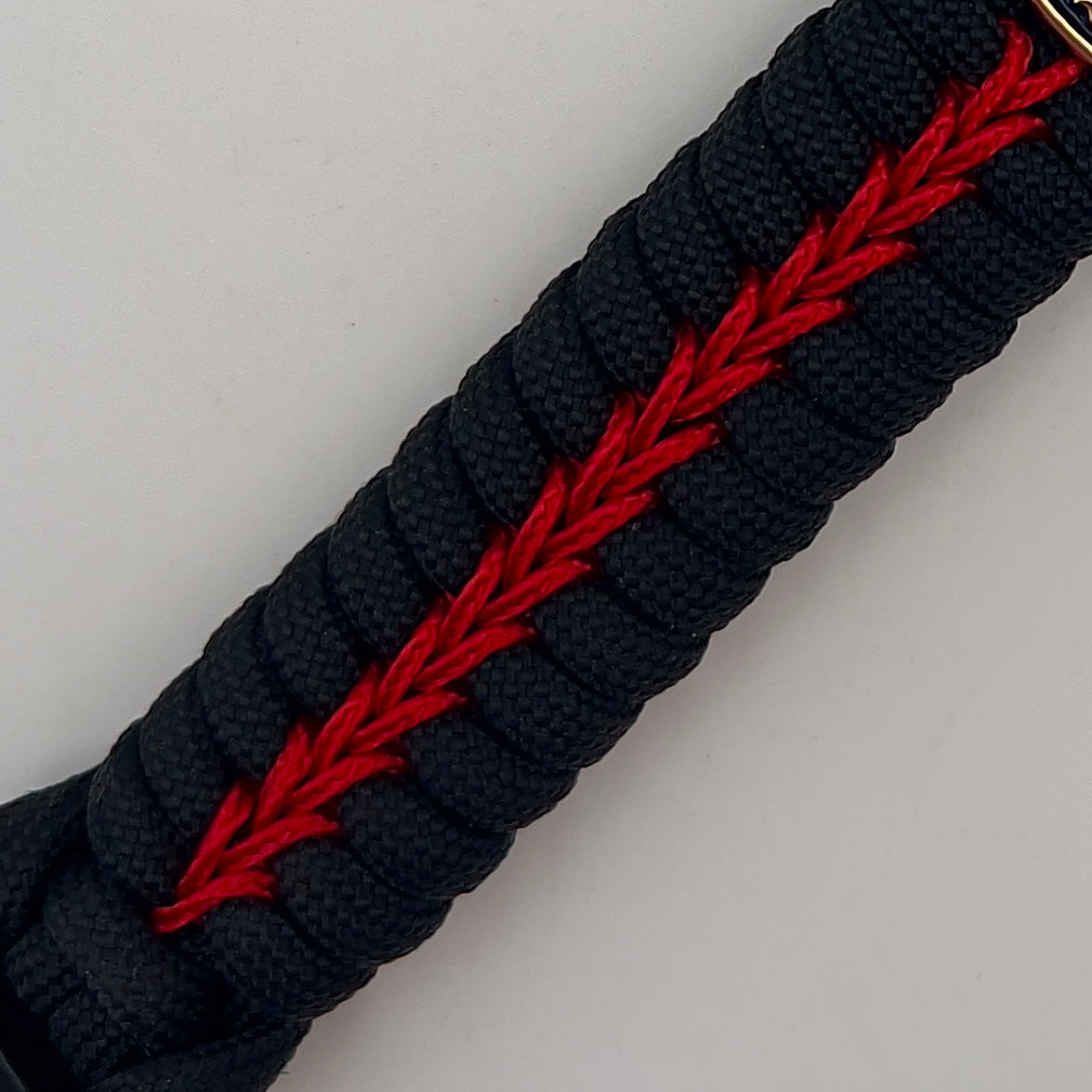 Thick, semi-rigid and comfortable braided United States Marine Corps bracelet featuring a 24K gold and silver plated USMC officer Eagle Globe and Anchor medallion, a black Cobra style tactical buckle and woven with black 550 and Imperial red micro paracord.