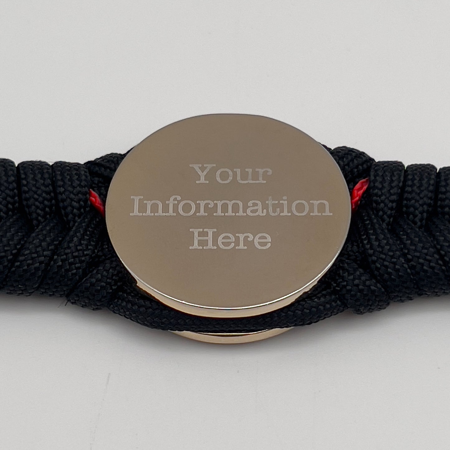 Thick, semi-rigid and comfortable braided United States Marine Corps bracelet featuring a 24K gold and silver plated USMC officer Eagle Globe and Anchor medallion, a black Cobra style tactical buckle and woven with black 550 and Imperial red micro paracord.