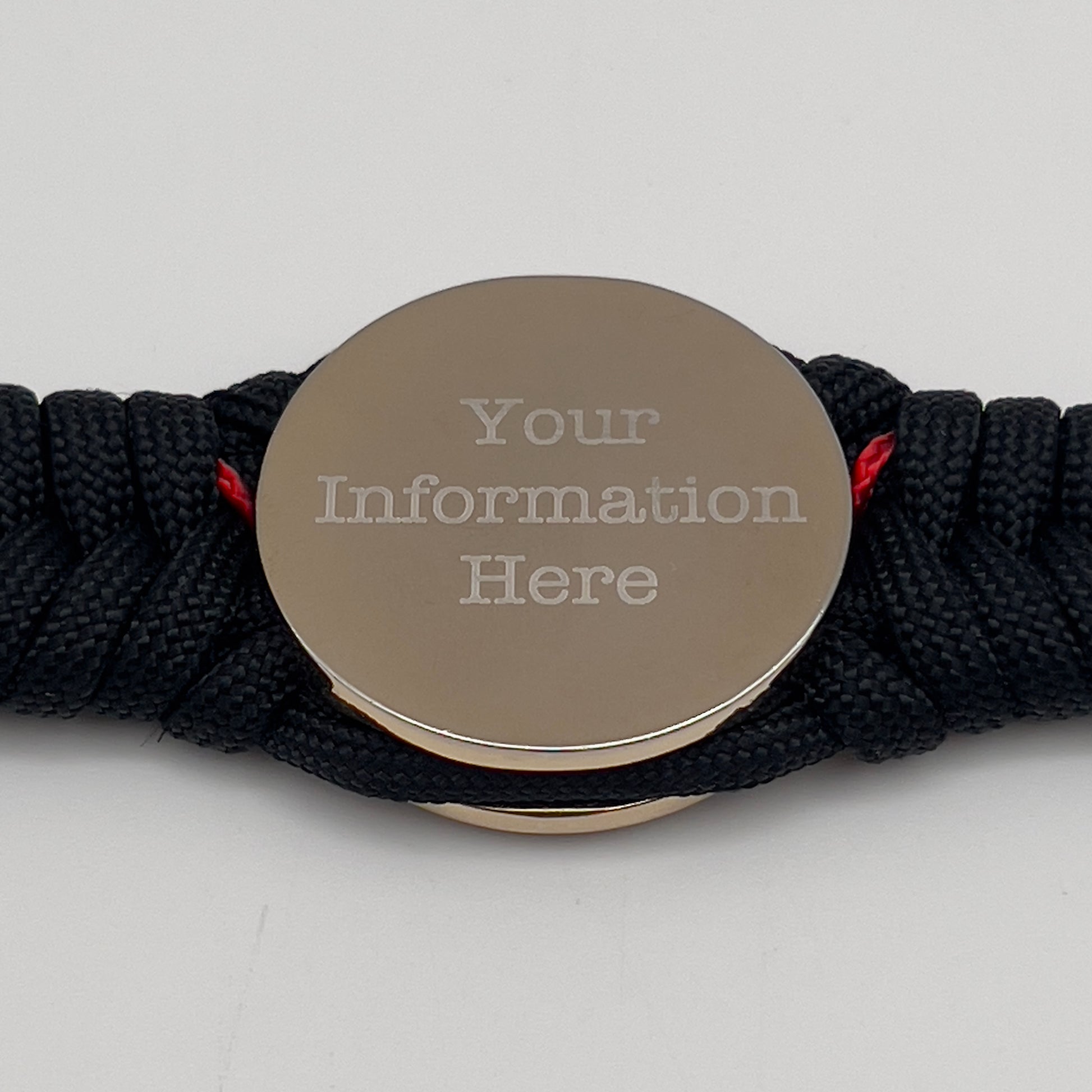Thick, semi-rigid and comfortable braided United States Marine Corps bracelet featuring a 24K gold and silver plated USMC officer Eagle Globe and Anchor medallion, a black Cobra style tactical buckle and woven with black 550 and Imperial red micro paracord.