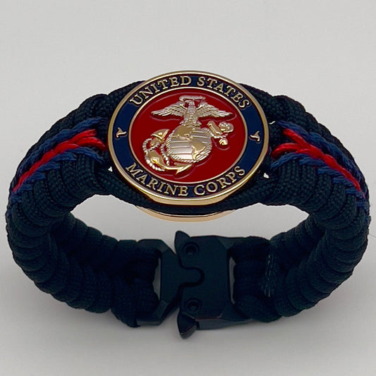 Thick, semi-rigid and comfortable braided United States Marine Corps bracelet featuring a 24K gold and silver plated USMC officer Eagle Globe and Anchor medallion, a black Cobra style tactical buckle and woven with Navy blue, Imperial red and black paracord.
