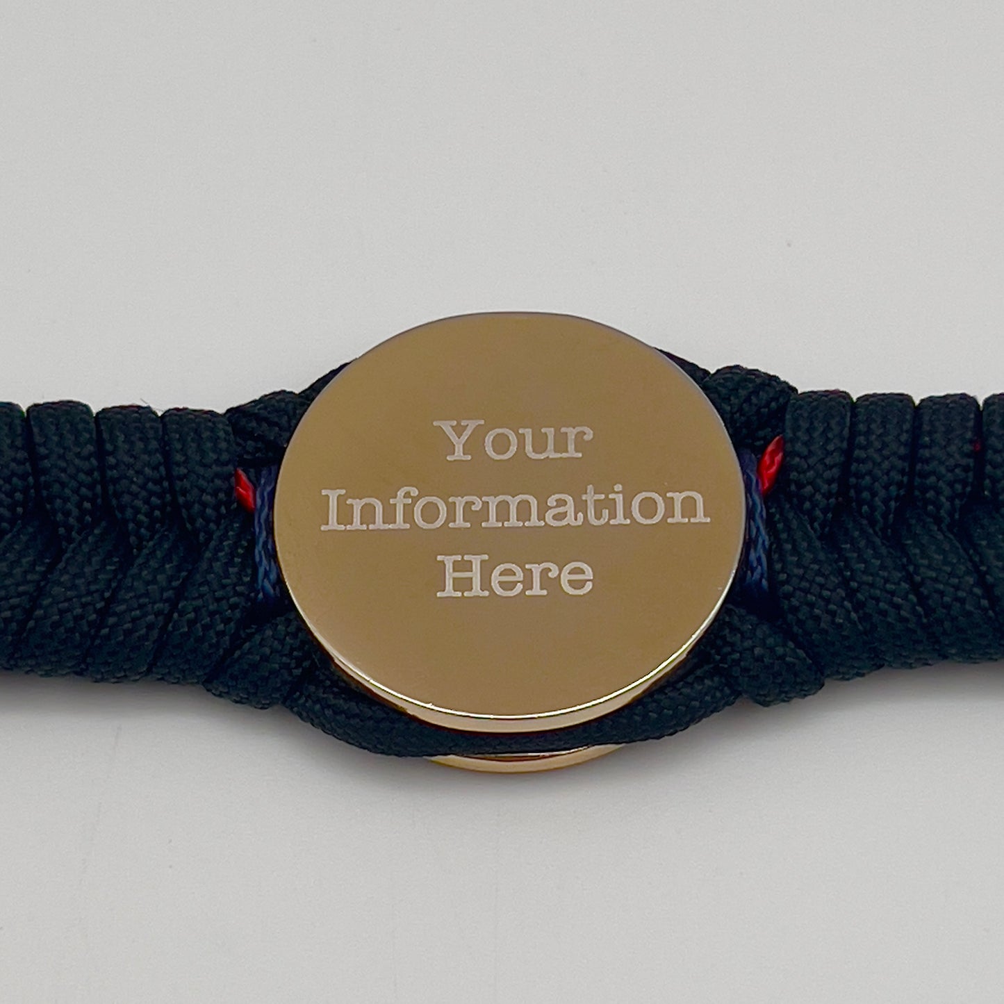 Thick, semi-rigid and comfortable braided United States Marine Corps bracelet featuring a 24K gold and silver plated USMC officer Eagle Globe and Anchor medallion, a black Cobra style tactical buckle and woven with Navy blue, Imperial red and black paracord.