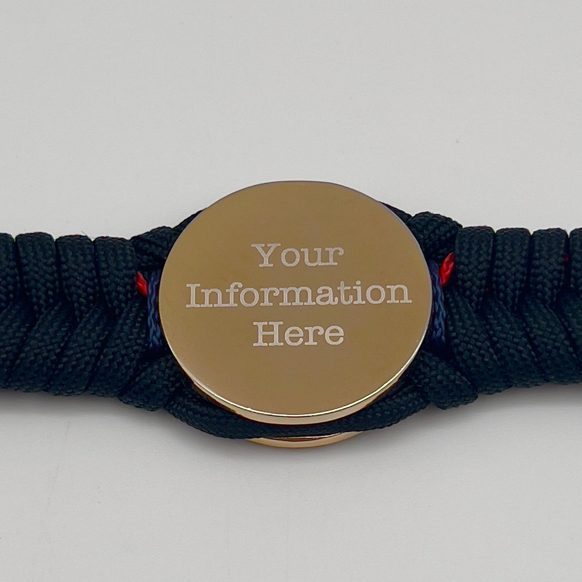 Thick, semi-rigid and comfortable braided United States Marine Corps bracelet featuring a 24K gold and silver plated USMC officer Eagle Globe and Anchor medallion, a black Cobra style tactical buckle and woven with Navy blue, Imperial red and black paracord.