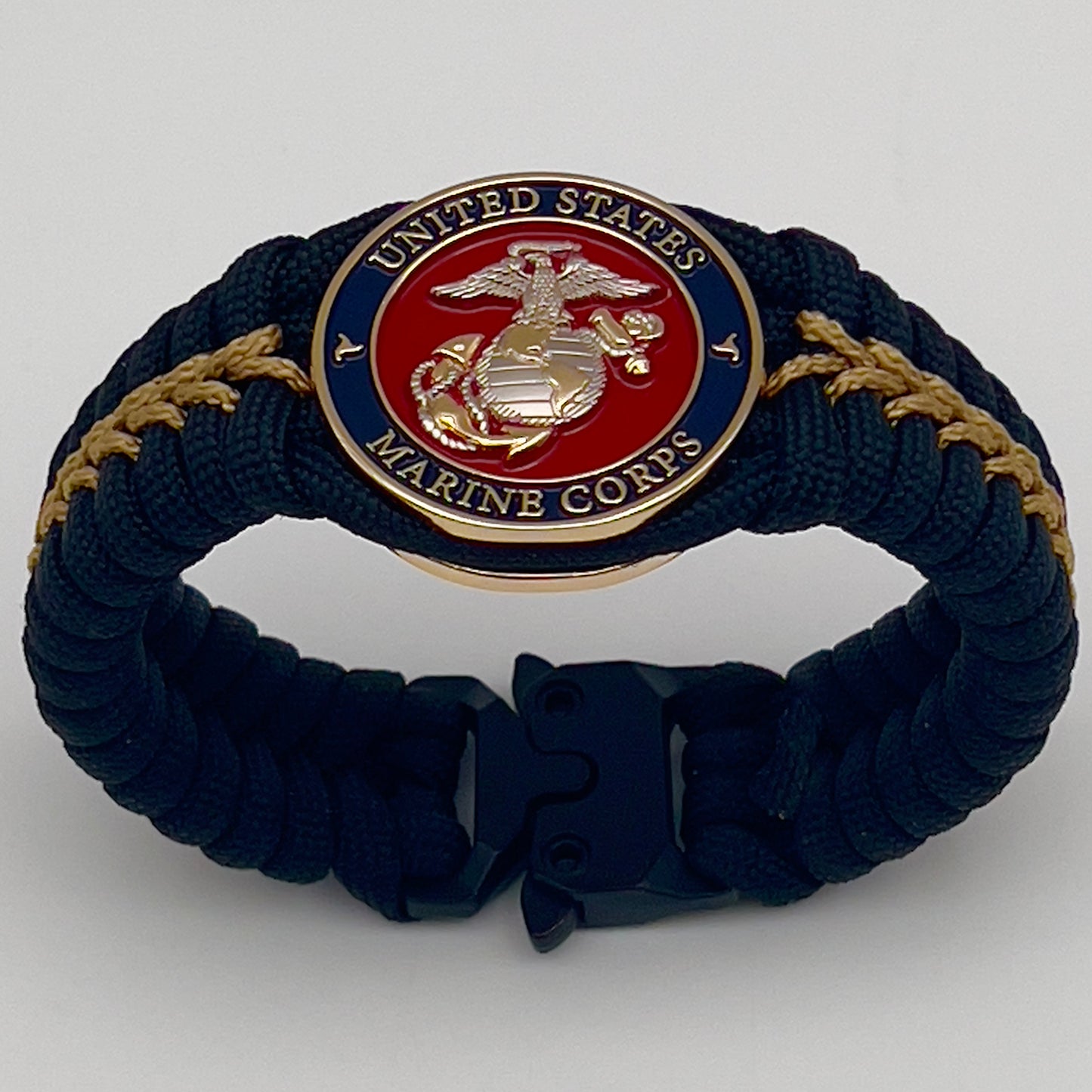 Thick, semi-rigid and comfortable braided United States Marine Corps bracelet featuring a 24K gold and silver plated USMC officer Eagle Globe and Anchor medallion, a black Cobra style tactical buckle and woven with black 550 and gold micro paracord.