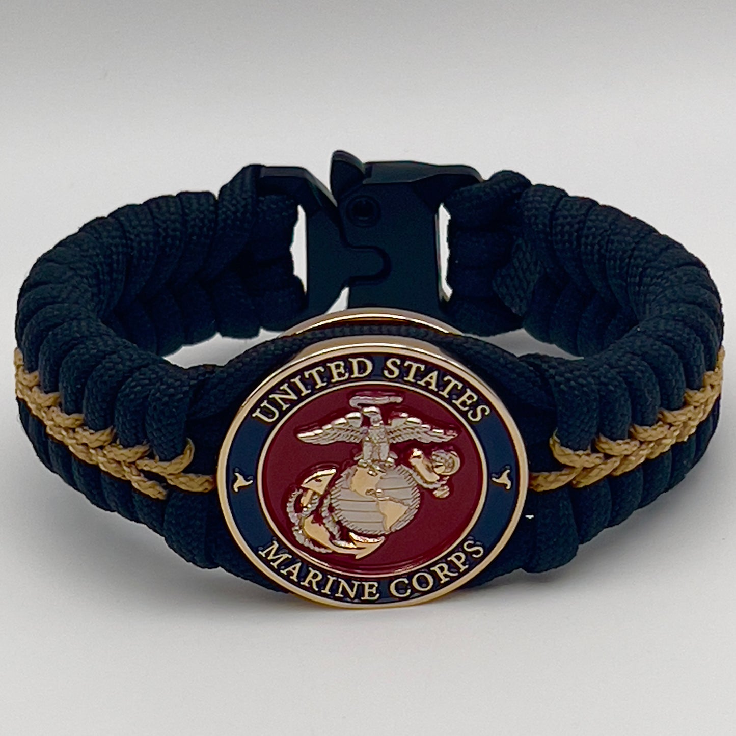 Thick, semi-rigid and comfortable braided United States Marine Corps bracelet featuring a 24K gold and silver plated USMC officer Eagle Globe and Anchor medallion, a black Cobra style tactical buckle and woven with black 550 and gold micro paracord.