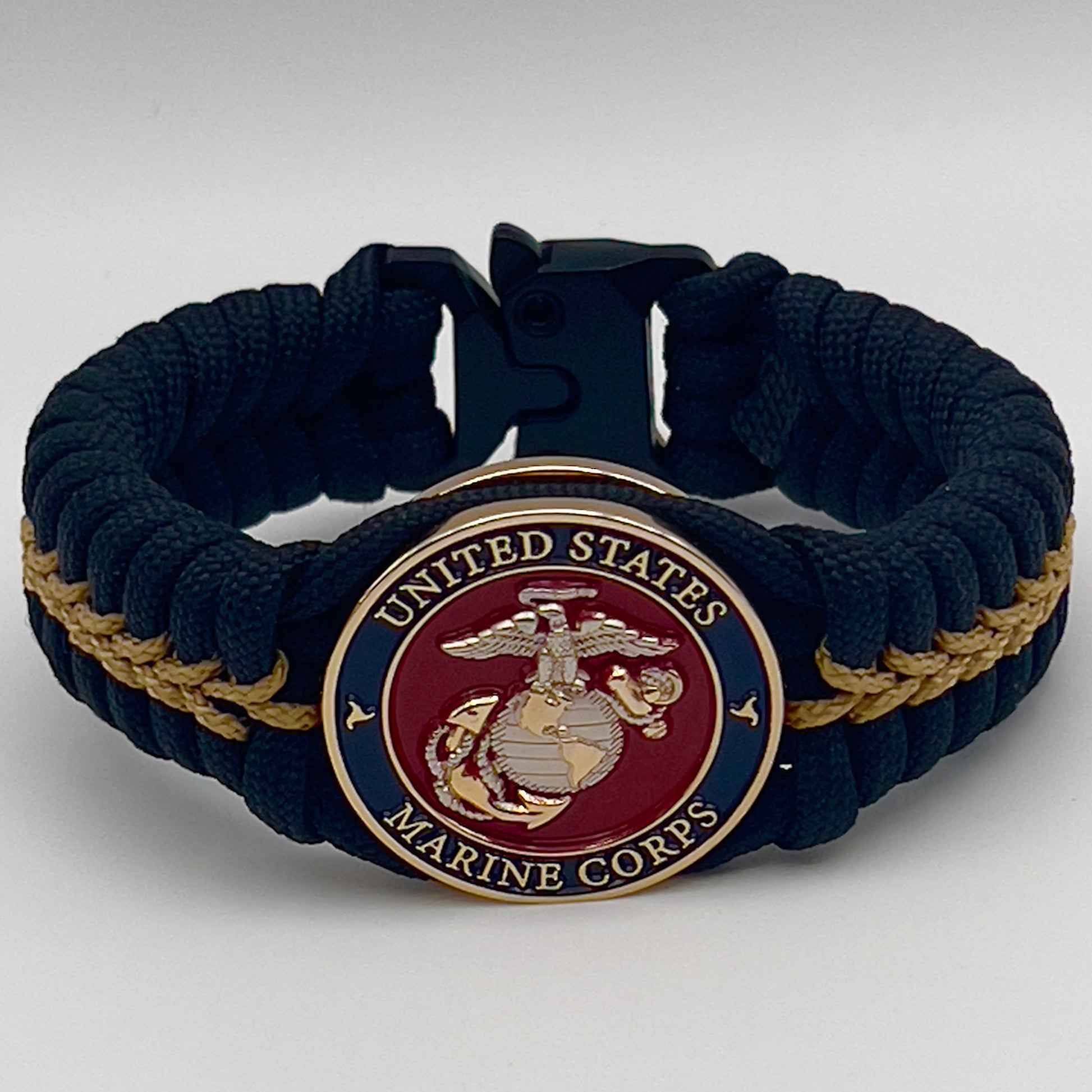 Thick, semi-rigid and comfortable braided United States Marine Corps bracelet featuring a 24K gold and silver plated USMC officer Eagle Globe and Anchor medallion, a black Cobra style tactical buckle and woven with black 550 and gold micro paracord.
