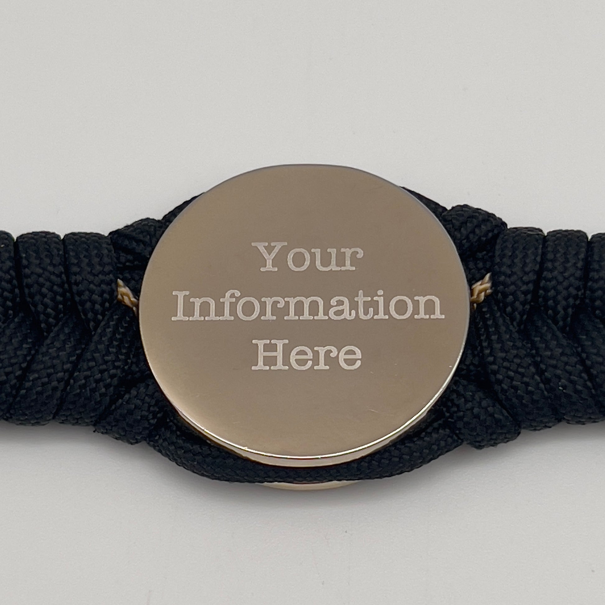 Thick, semi-rigid and comfortable braided United States Marine Corps bracelet featuring a 24K gold and silver plated USMC officer Eagle Globe and Anchor medallion, a black Cobra style tactical buckle and woven with black 550 and gold micro paracord.