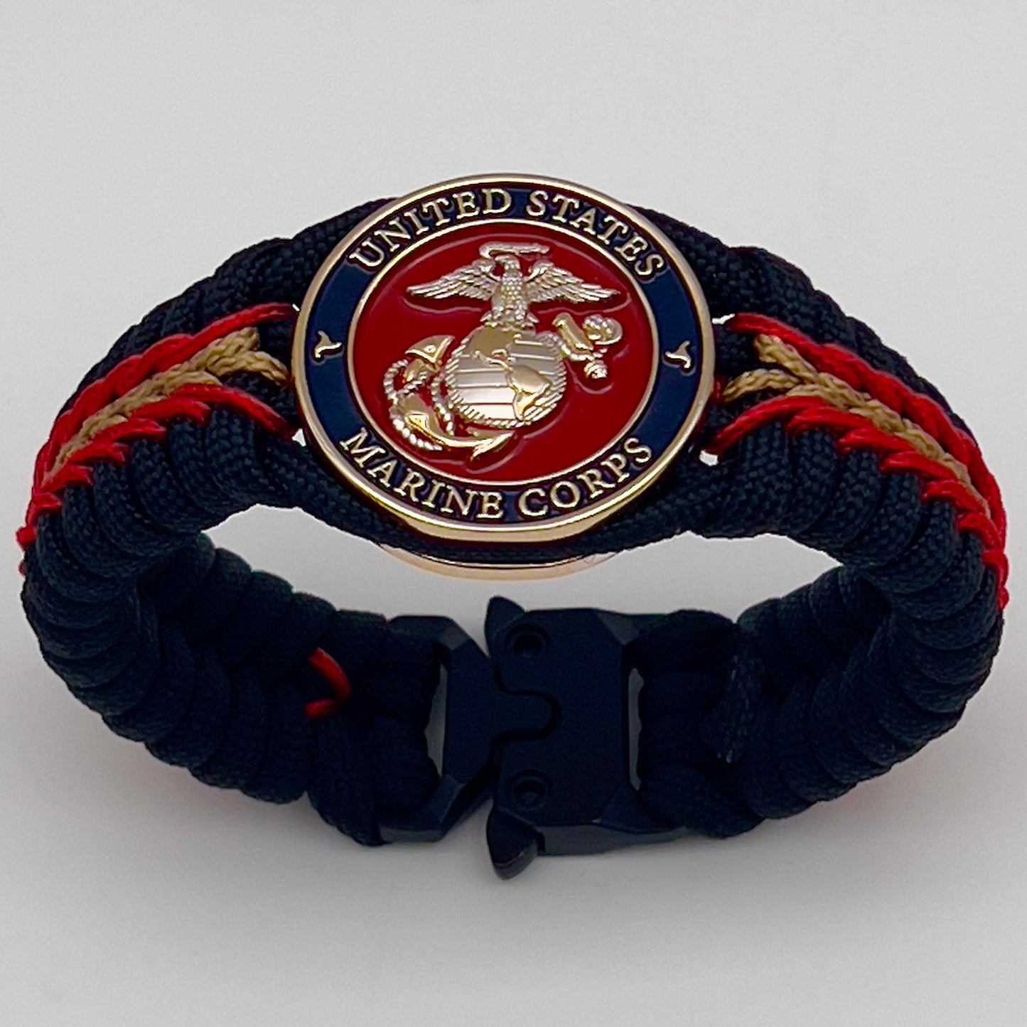 Thick, semi-rigid and comfortable braided United States Marine Corps bracelet featuring a 24K gold and silver plated USMC officer Eagle Globe and Anchor medallion, a black Cobra style tactical buckle and woven with black 550, Imperial red and gold micro paracord.