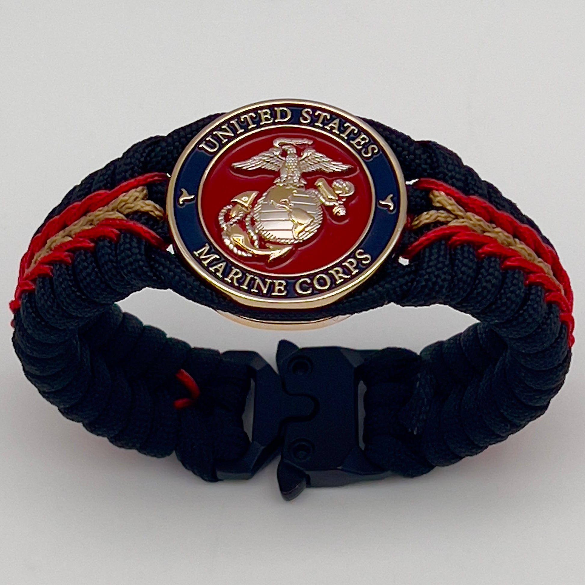 Thick, semi-rigid and comfortable braided United States Marine Corps bracelet featuring a 24K gold and silver plated USMC officer Eagle Globe and Anchor medallion, a black Cobra style tactical buckle and woven with black 550, Imperial red and gold micro paracord.