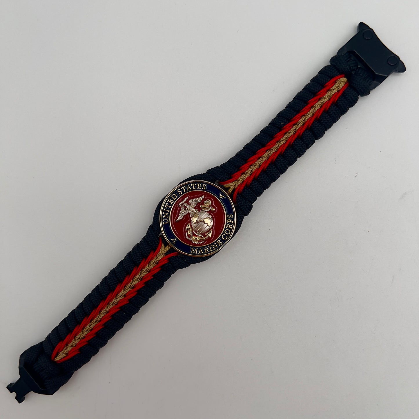Thick, semi-rigid and comfortable braided United States Marine Corps bracelet featuring a 24K gold and silver plated USMC officer Eagle Globe and Anchor medallion, a black Cobra style tactical buckle and woven with black 550, Imperial red and gold micro paracord.