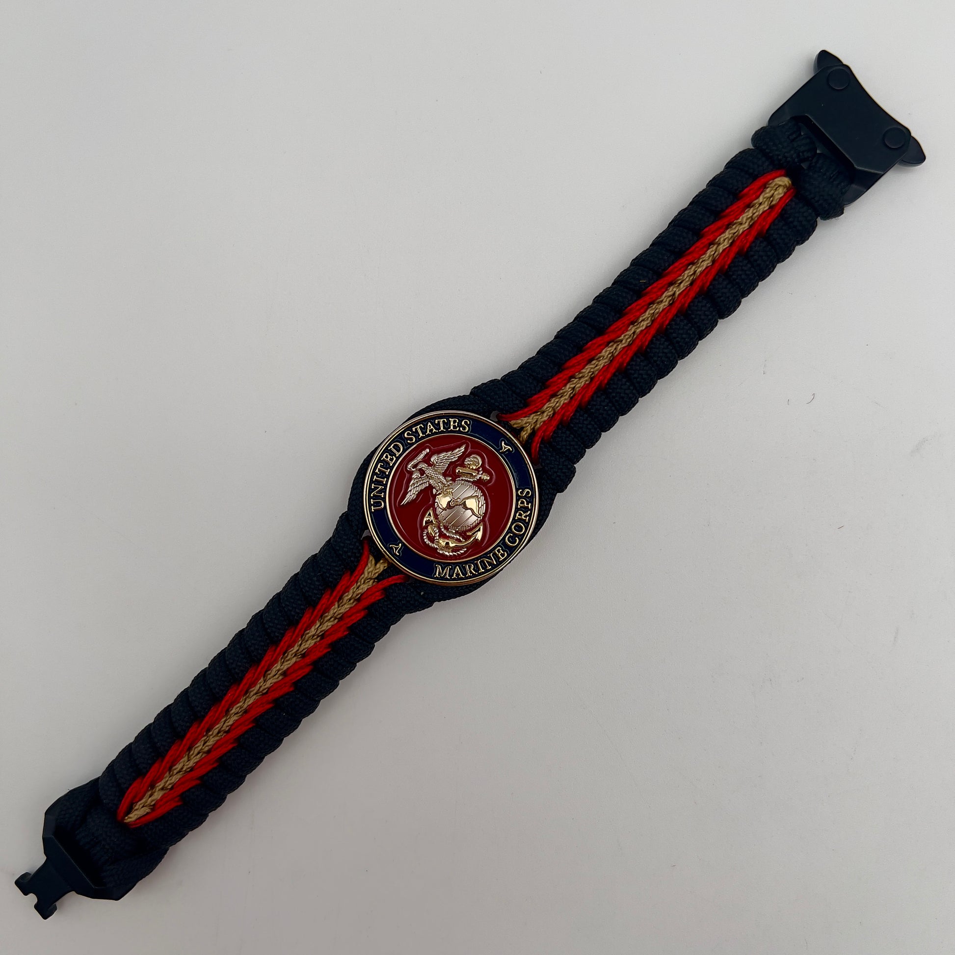Thick, semi-rigid and comfortable braided United States Marine Corps bracelet featuring a 24K gold and silver plated USMC officer Eagle Globe and Anchor medallion, a black Cobra style tactical buckle and woven with black 550, Imperial red and gold micro paracord.